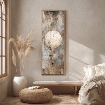 a serene and minimalist bedroom with a large window, a bed with white bedding, a wicker ottoman, and a framed artwork featuring a large circular design on the wall.