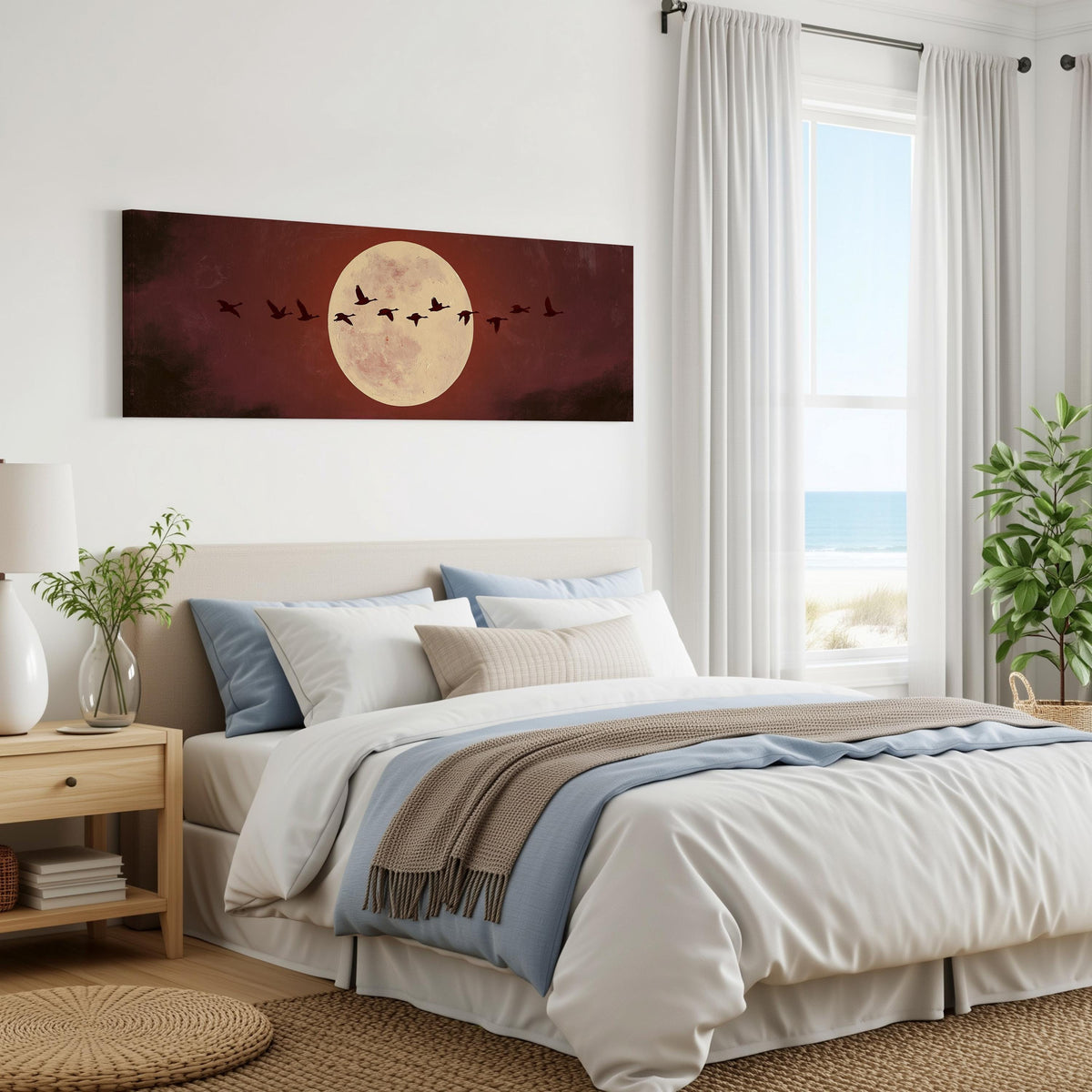Geese crossing a pale moon on maroon panoramic canvas print above a bed in a coastal bedroom