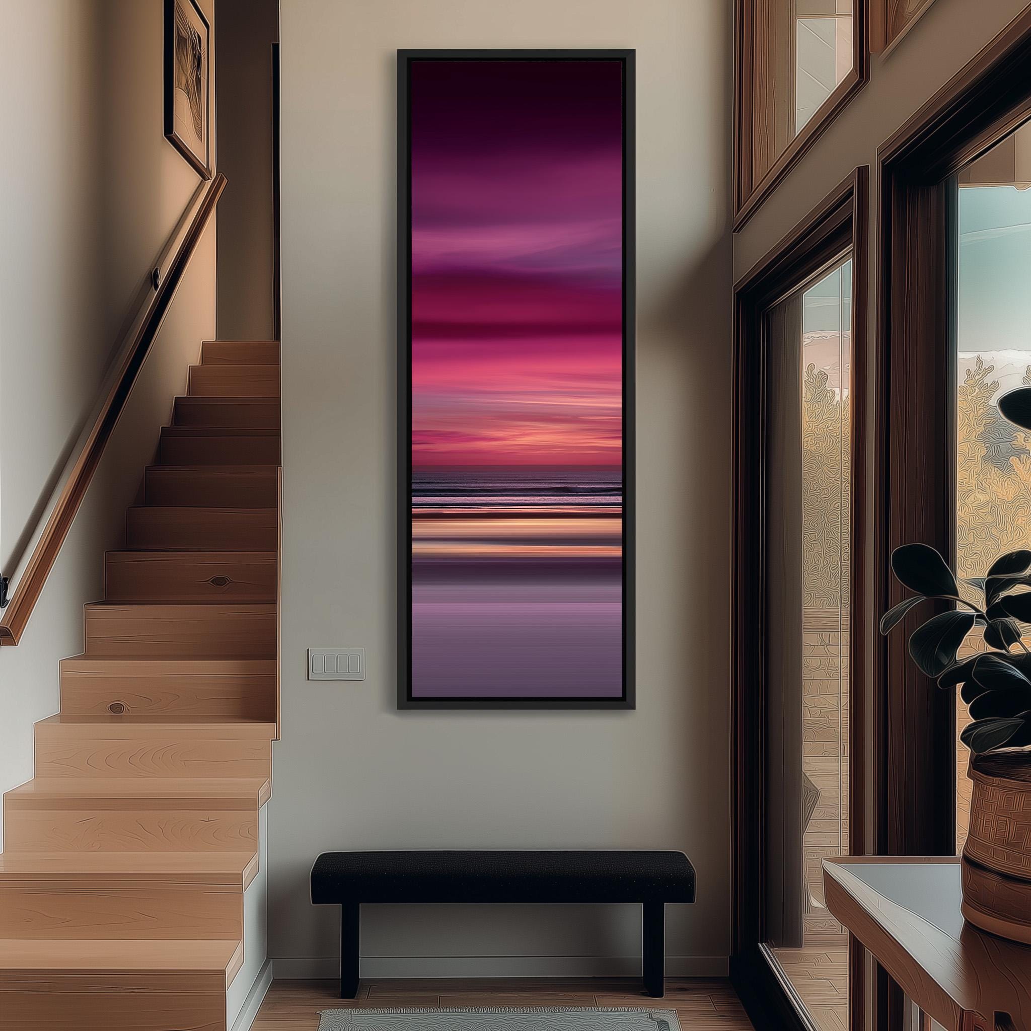 a modern interior design with a large window, a wooden staircase, and a black bench. The focal point is a large painting depicting a sunset over the ocean, with a gradient of pink and purple colors.