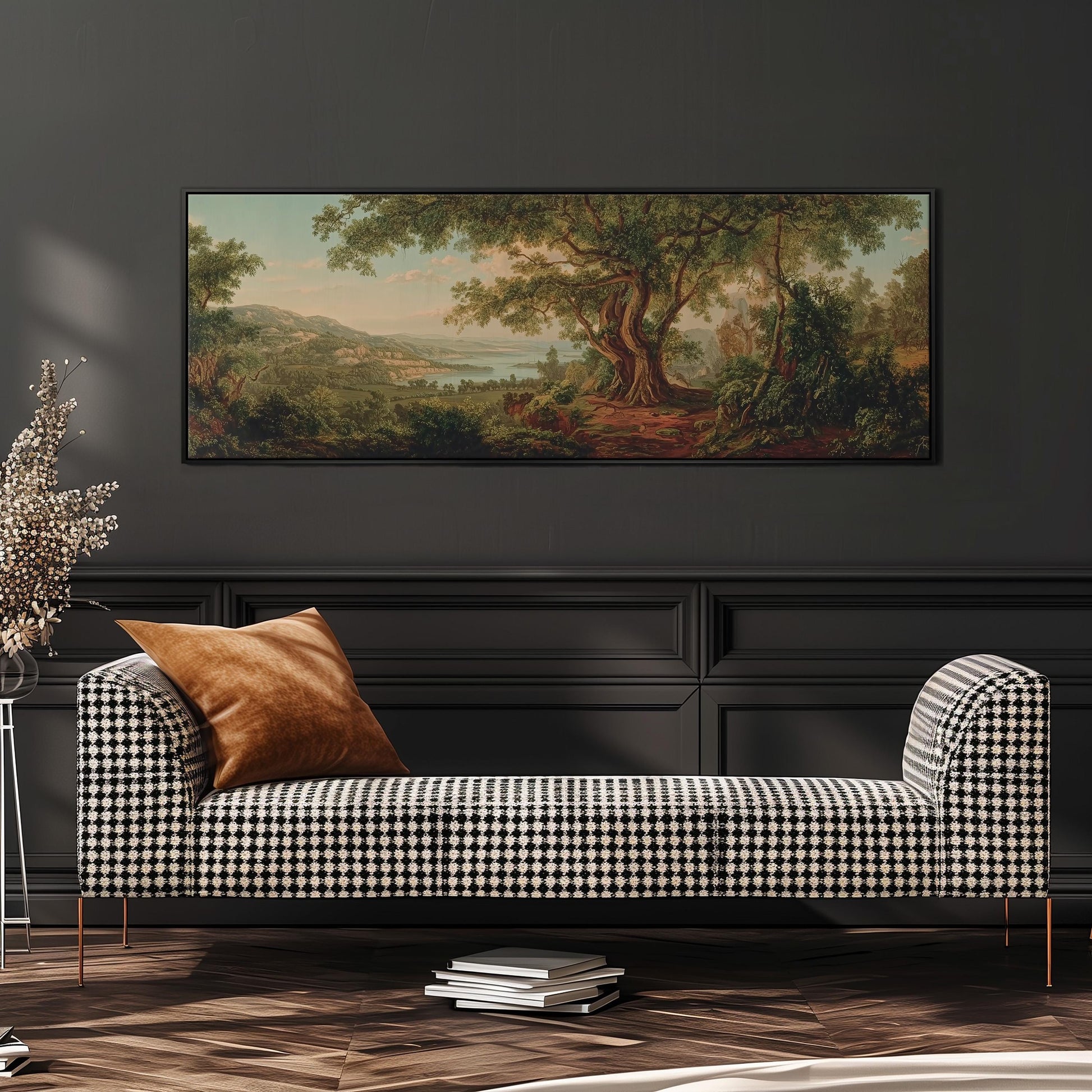 a large painting of a forest landscape hanging on a wall above a black and white checkered sofa with a brown throw pillow.