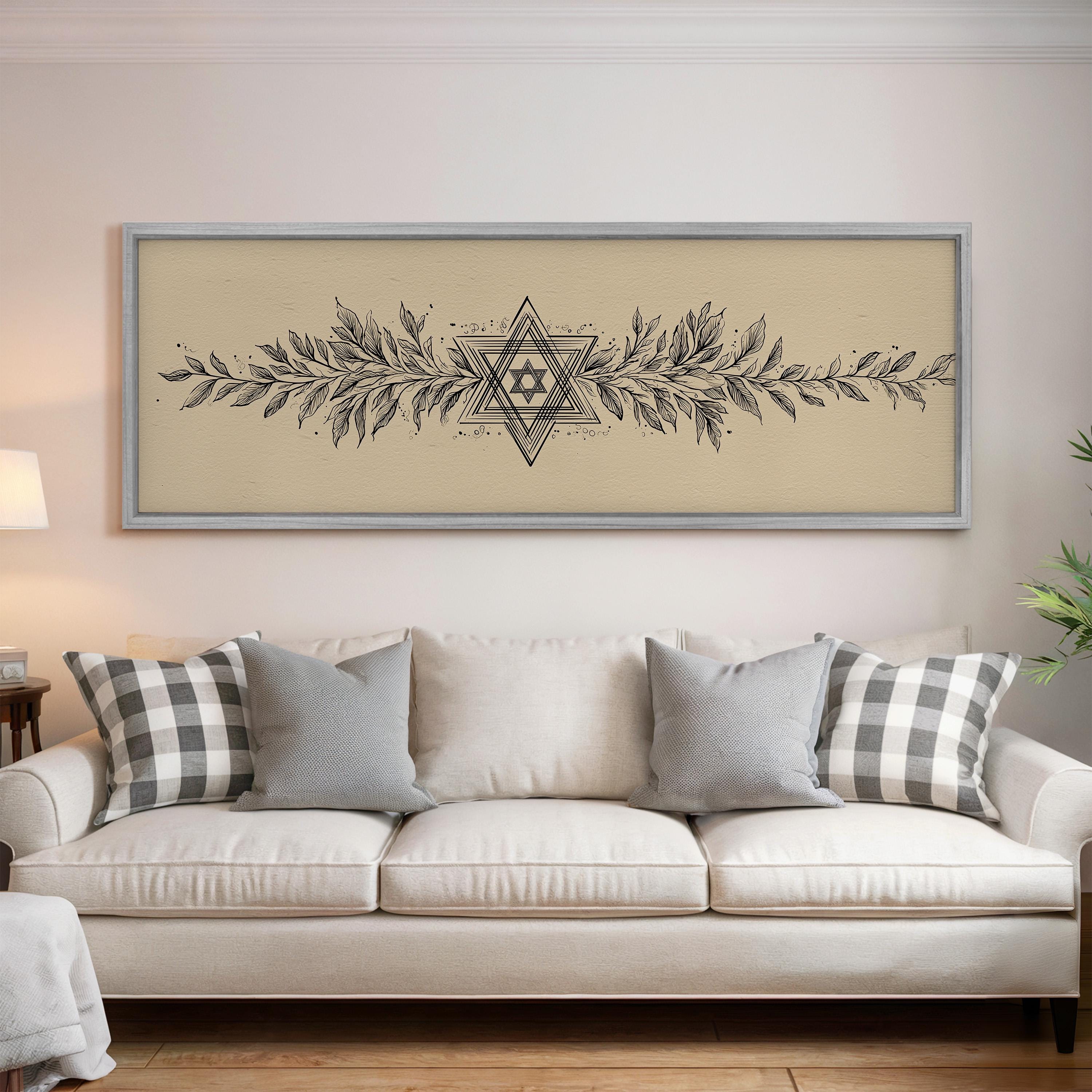 a living room with a white sofa and a framed artwork hanging on the wall above it.