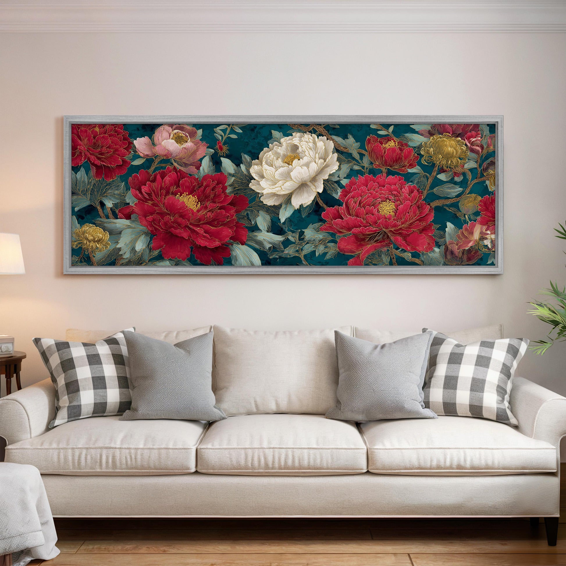 a large floral painting hanging on a wall above a white couch with gray and white plaid throw pillows.