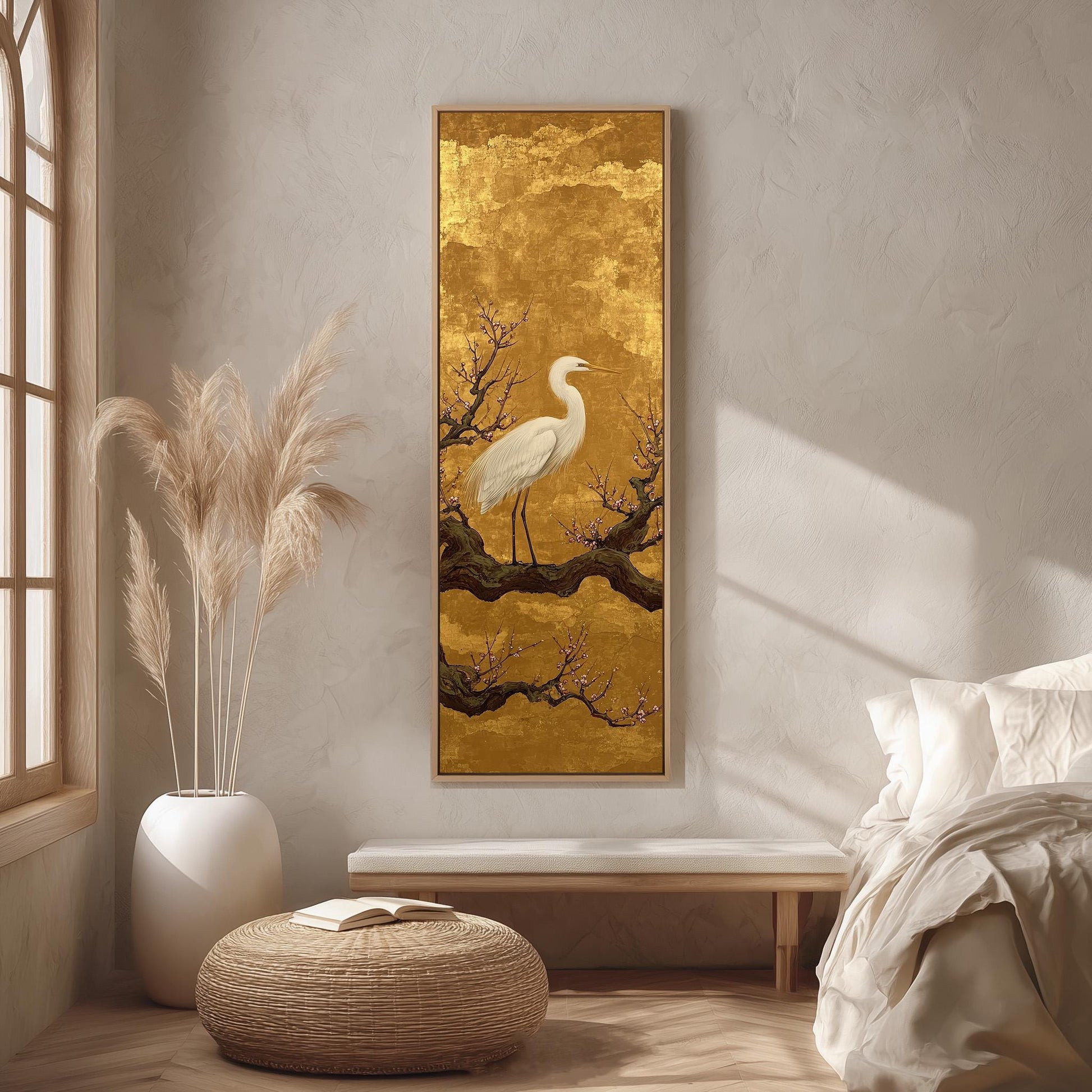 a serene bedroom setting with a large painting of a white crane perched on a branch, a white vase with tall pampas grasses, a wooden bench, and a white ottoman.