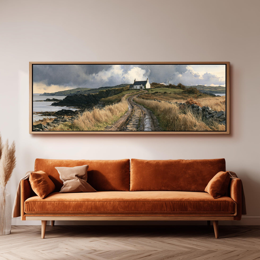 Dirt road to a coastal cottage under dramatic clouds long horizontal canvas print above a sofa in a living room
