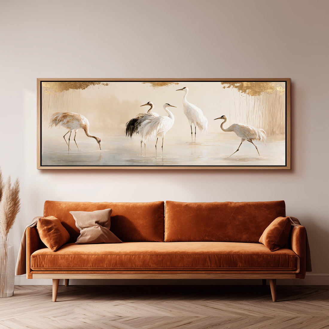 Group of cranes wading in soft light long horizontal canvas print above a sofa in a living room