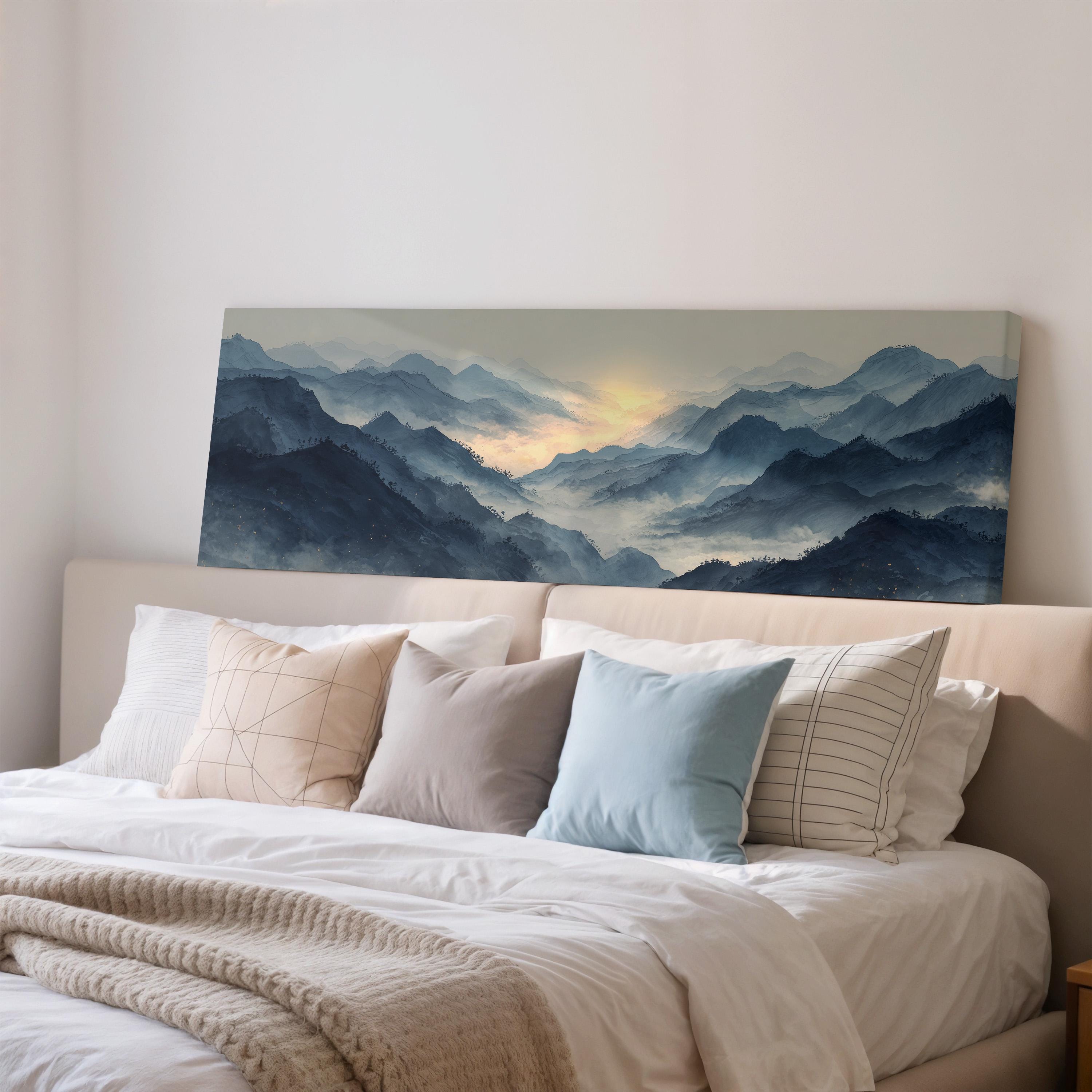 a large landscape painting hanging on a wall above a bed with white bedding and pillows.