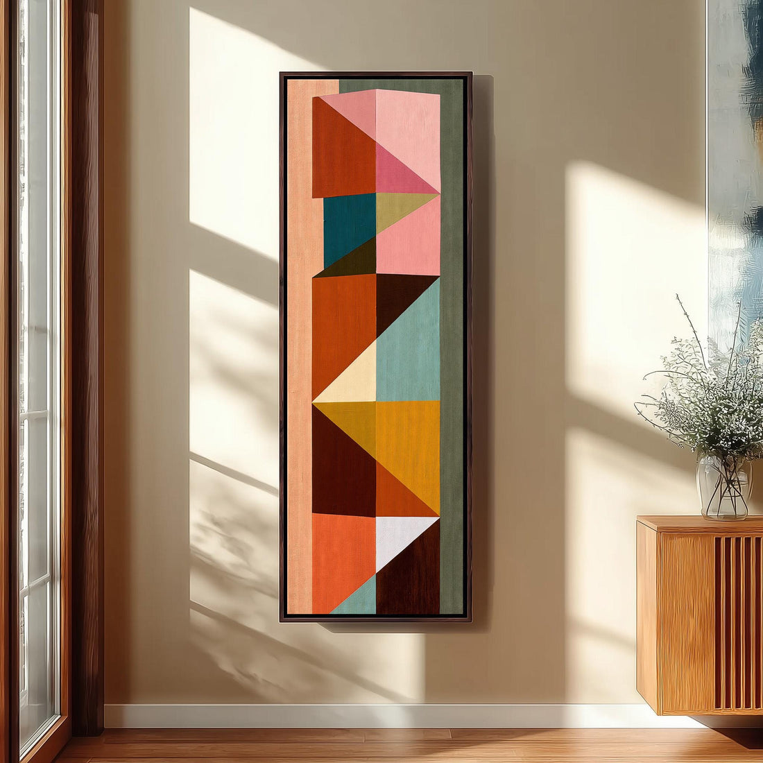Stacked colorful triangle mosaic long vertical canvas print in a sunlit living space