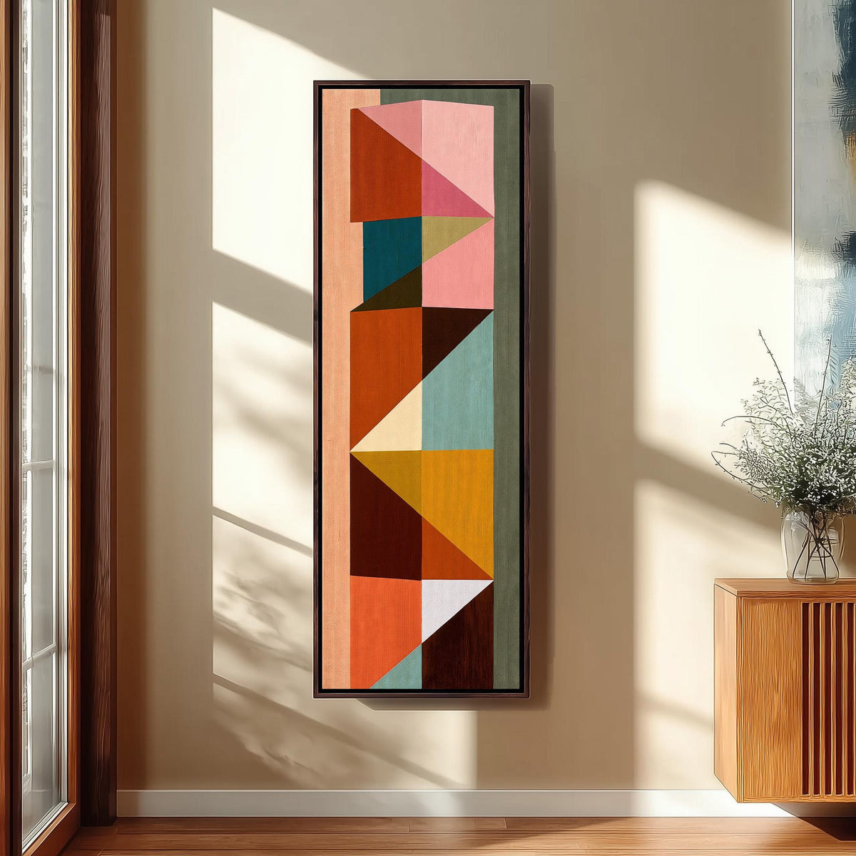 Stacked colorful triangle mosaic long vertical canvas print in a sunlit living space