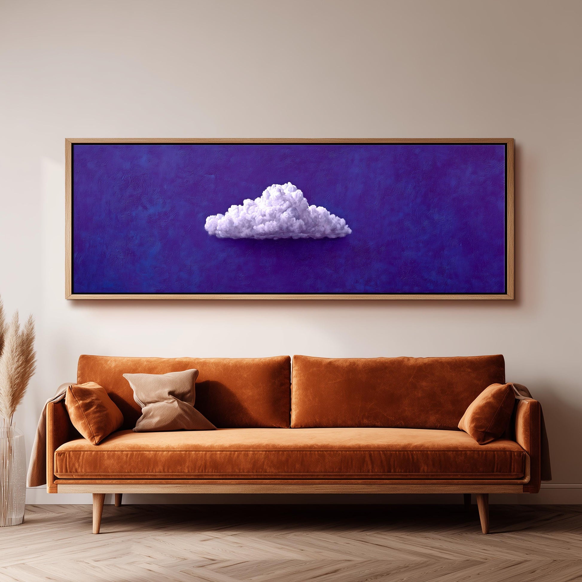 a large, framed painting of a cloud on a purple background, hanging on a wall above a brown sofa.