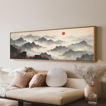 Misty ink mountains under a red sun long horizontal canvas print above a sofa in a living room