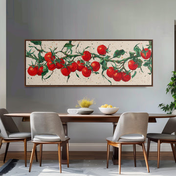 a dining room with a wooden table and four chairs. Above the table, there is a large painting of tomatoes hanging on the wall. The painting has a white background and depicts a branch with red tomatoes growing on it. The dining table is set with a bowl of fruit and a vase of flowers, creating a cozy and inviting atmosphere.