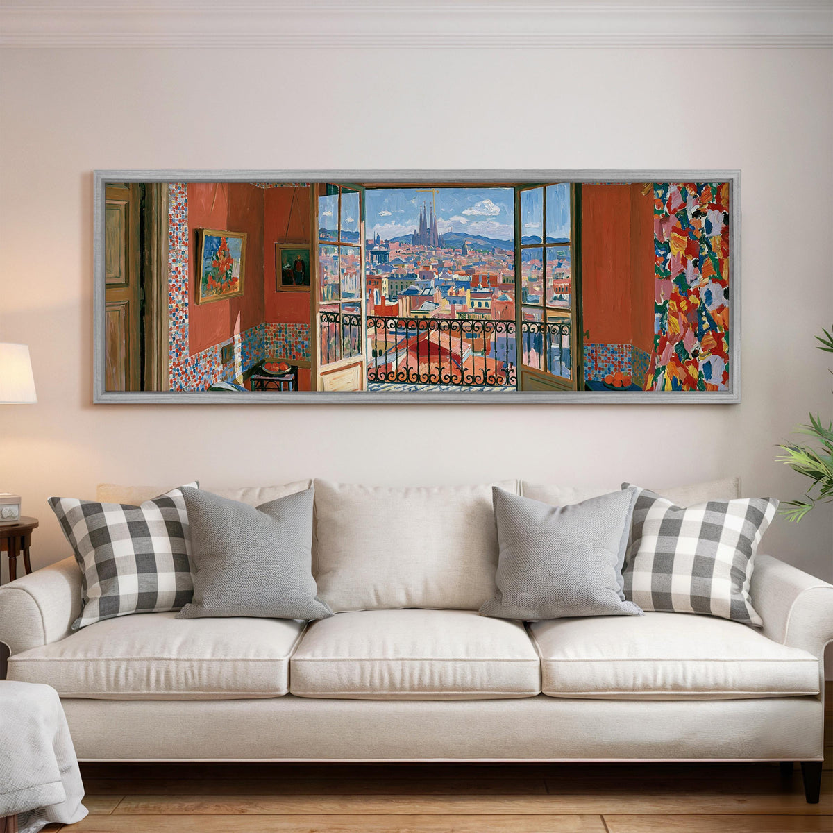 Barcelona seen through an open window panoramic canvas print above a white sofa in a bright living room