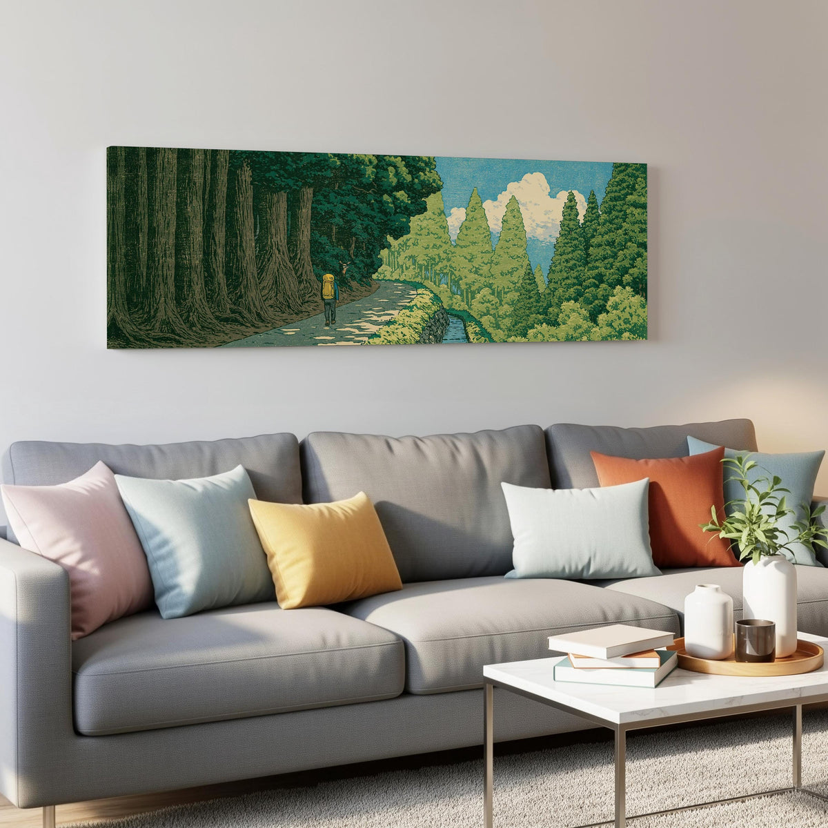 Hiker on a forest trail panoramic canvas print above a grey sofa in a living room