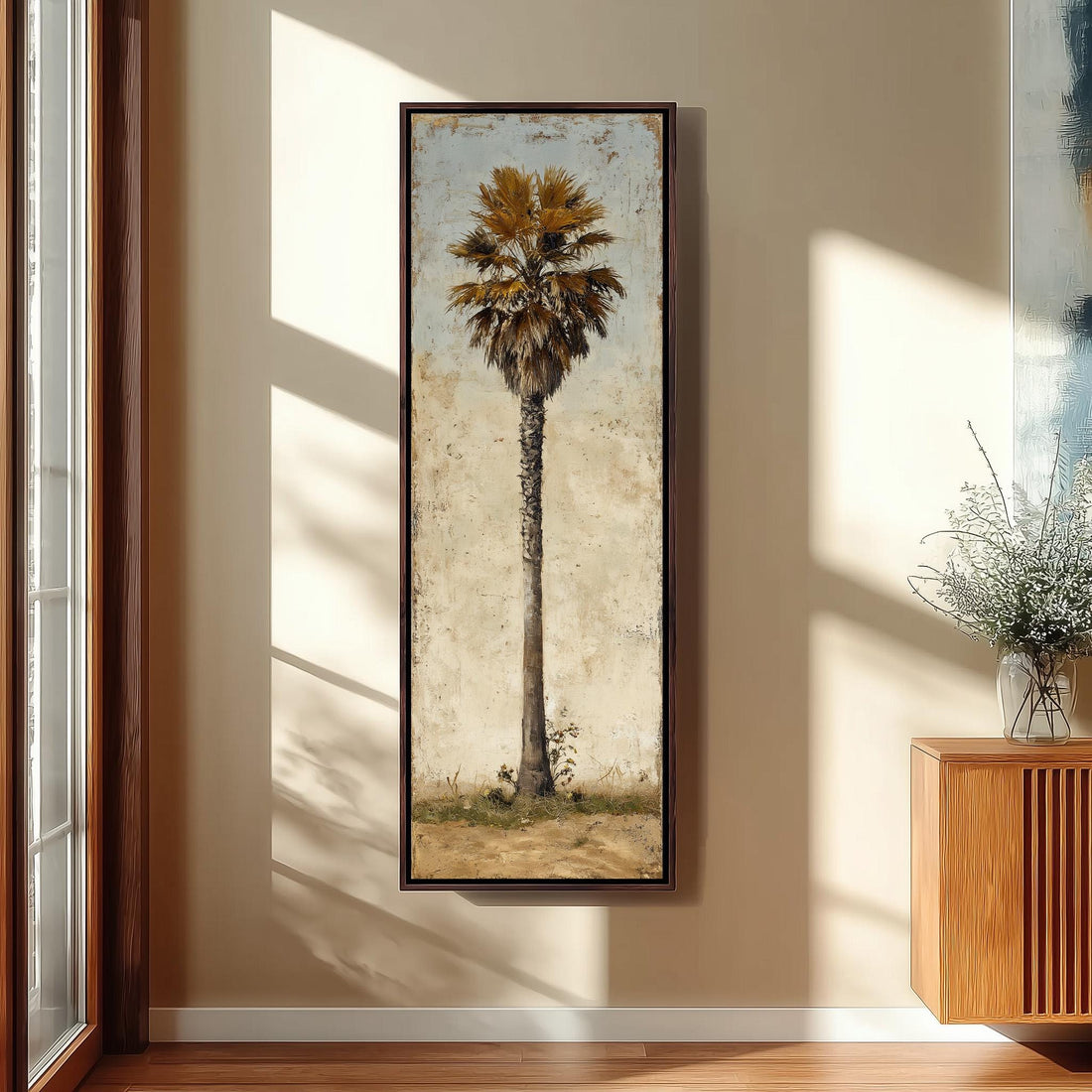a large framed painting of a palm tree hanging on a wall in a room with a seating area and decorative elements.