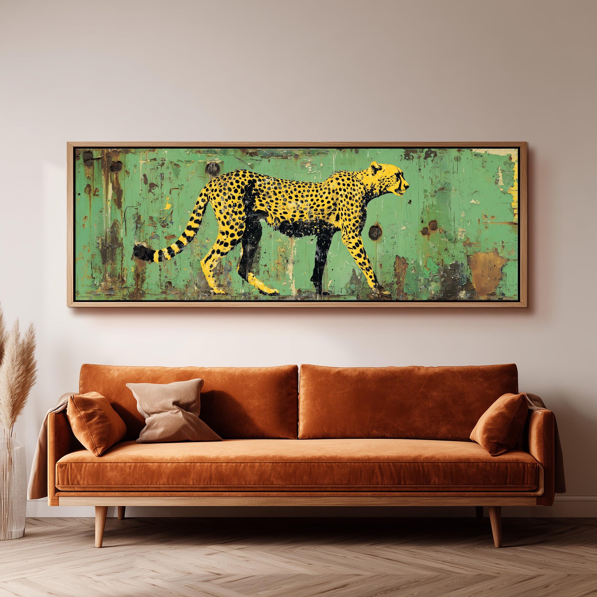 a large, vibrant painting of a cheetah on a green background, hanging on a wall above a brown sofa.
