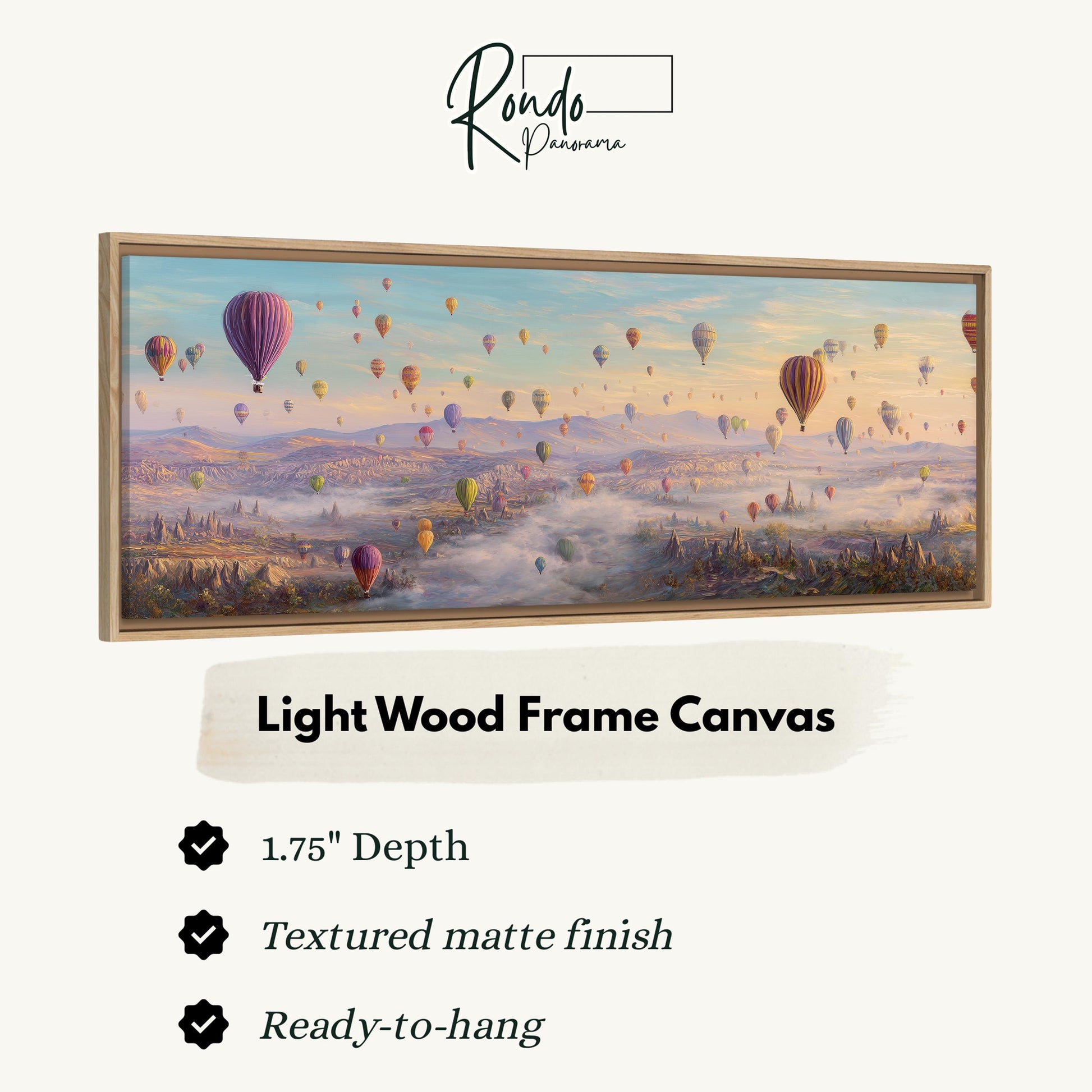 A framed painting depicting a scenic landscape with hot air balloons floating over a misty valley.