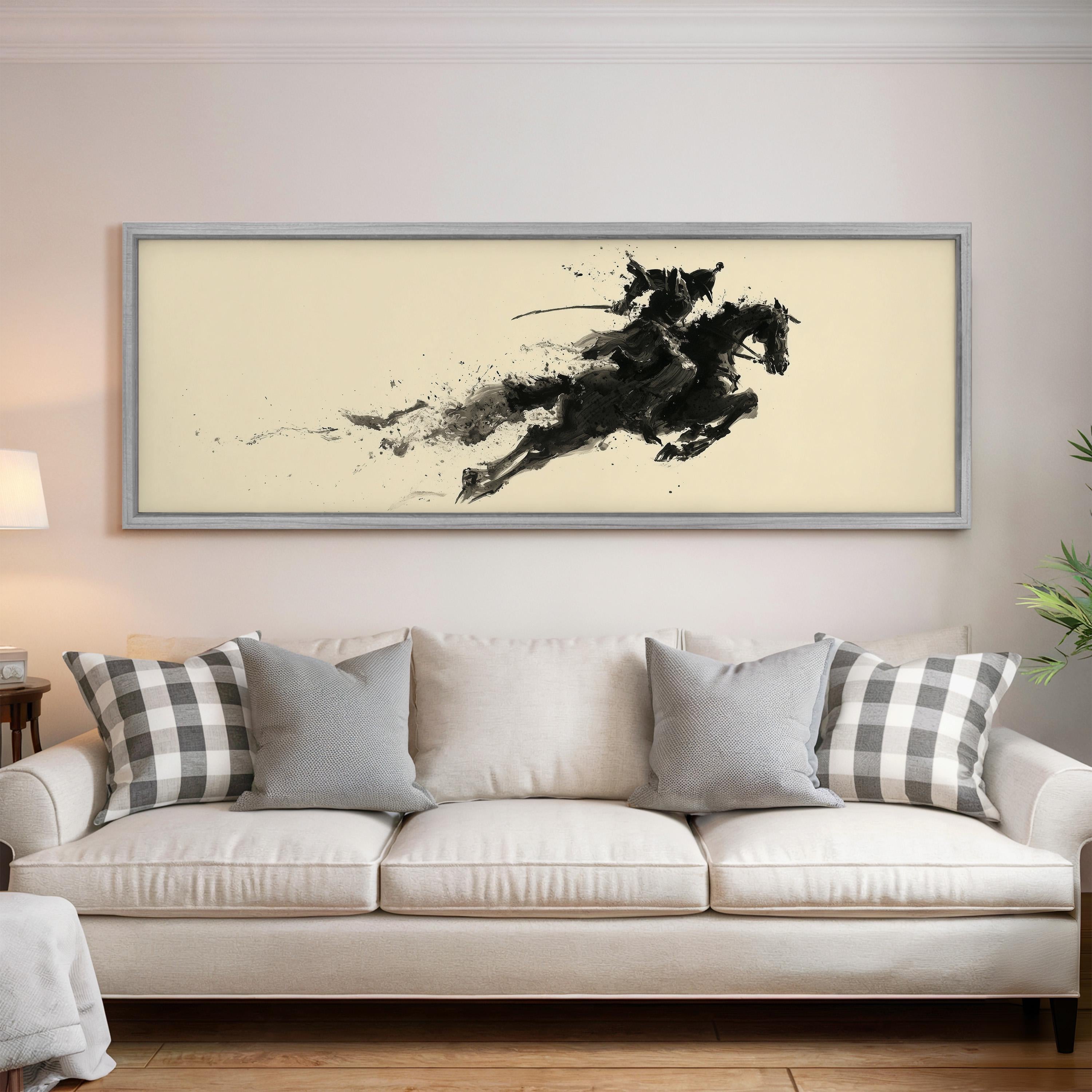 a large, framed artwork of a horse and rider on a wall above a white couch with gray and white plaid throw pillows.