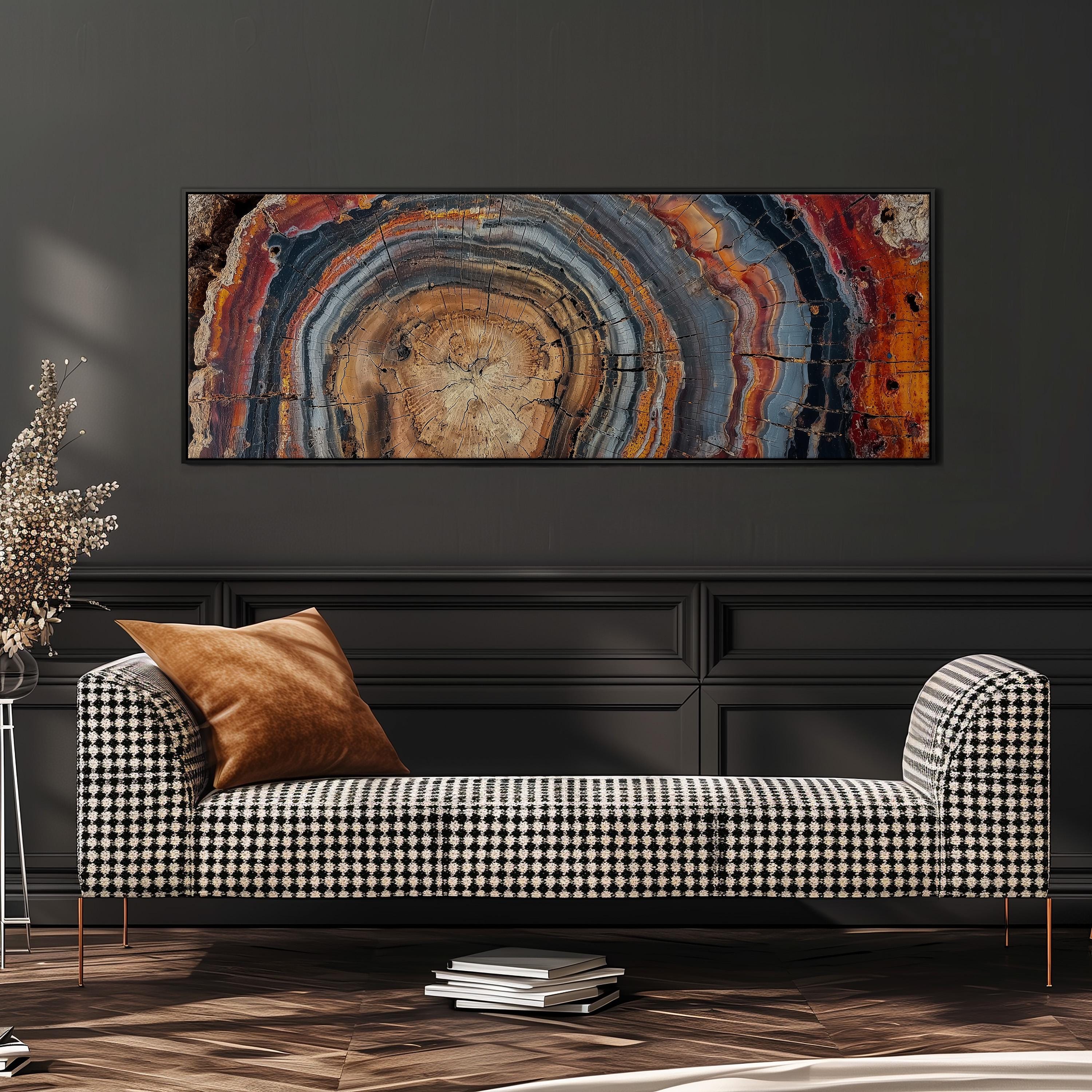 a checkered black and white sofa with a brown throw pillow, set against a dark wall with a large abstract painting hanging above it.