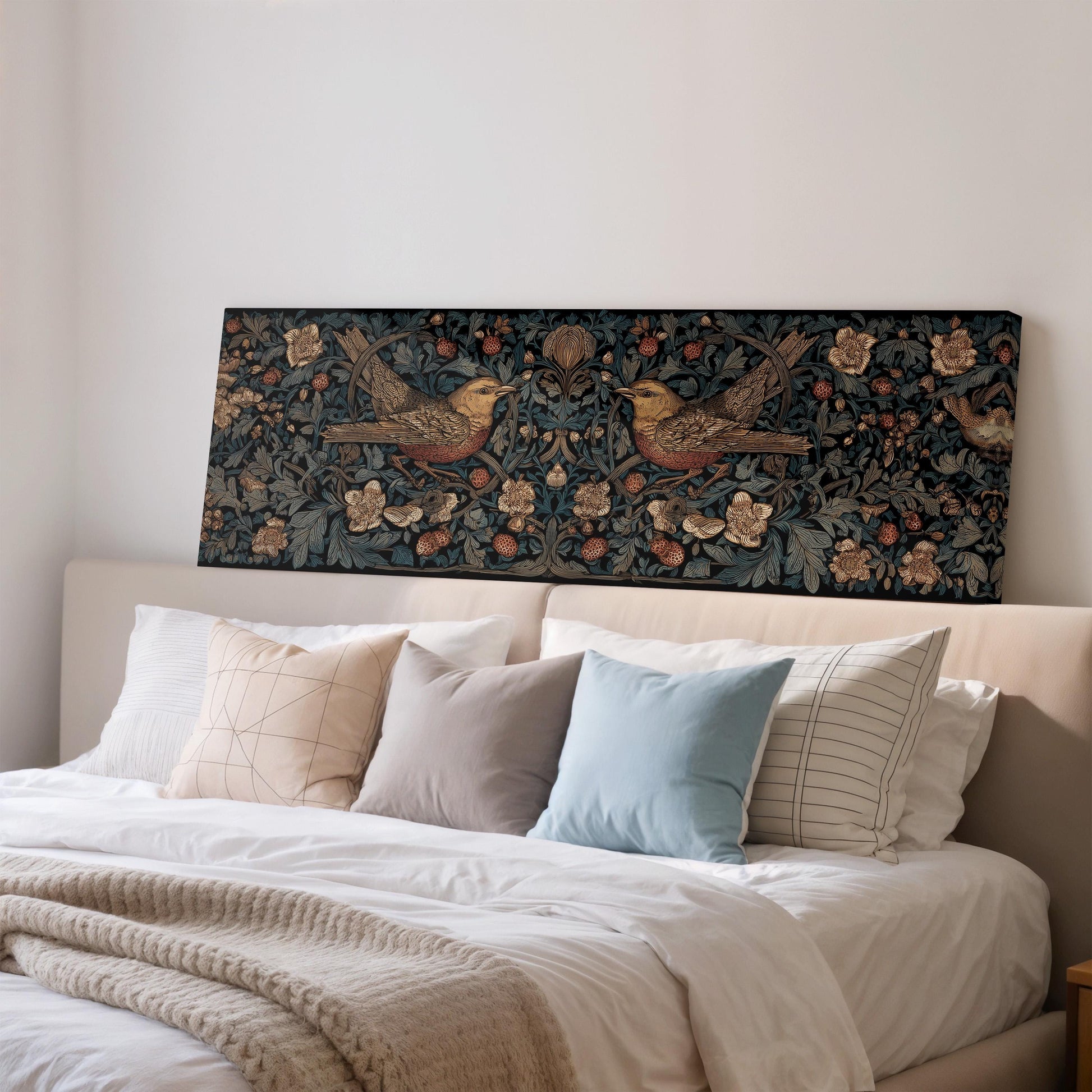 a bedroom with a large bed adorned with white linens and a variety of pillows. Above the bed, there is a large tapestry or painting featuring two birds, possibly a quilt or a decorative piece. The overall scene has a cozy and inviting atmosphere.