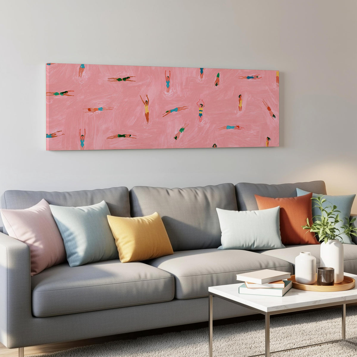 Tiny swimmers in a pink pool from above panoramic canvas print above a grey sofa in a living room