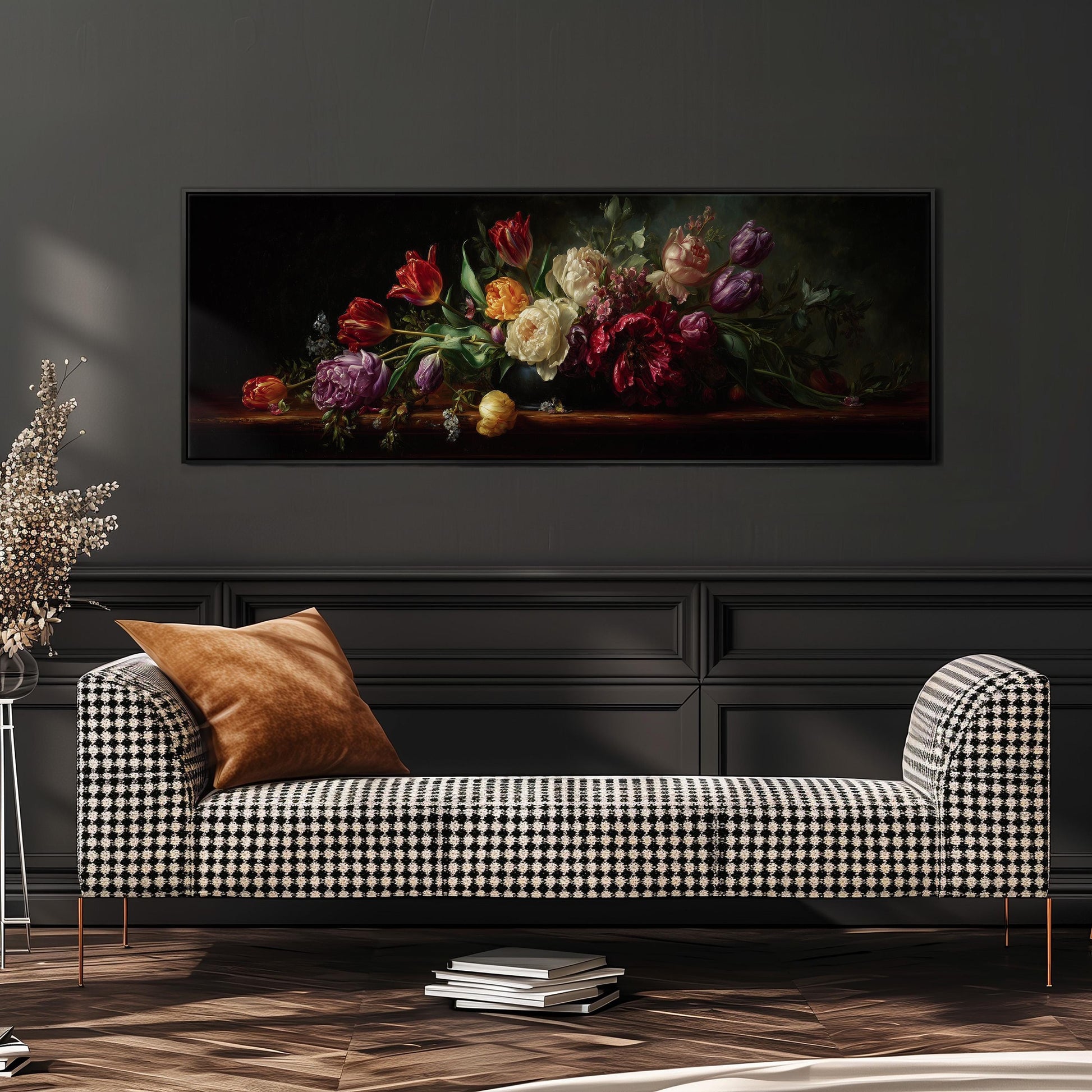 a large painting of a bouquet of flowers hanging on a wall above a black and white checkered sofa.