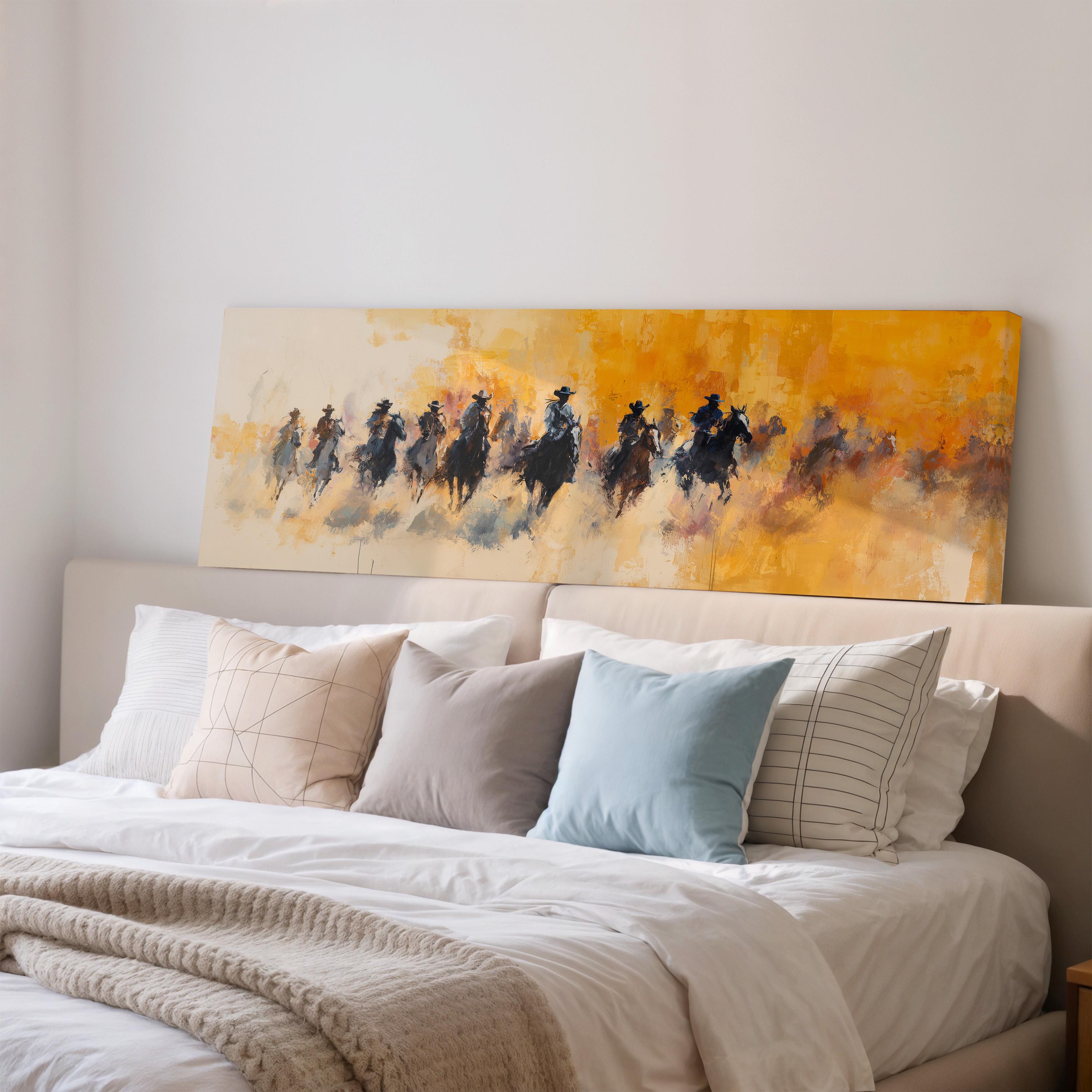a large painting of a group of people riding horses on a yellow background, hanging above a bed with white pillows and a gray blanket.