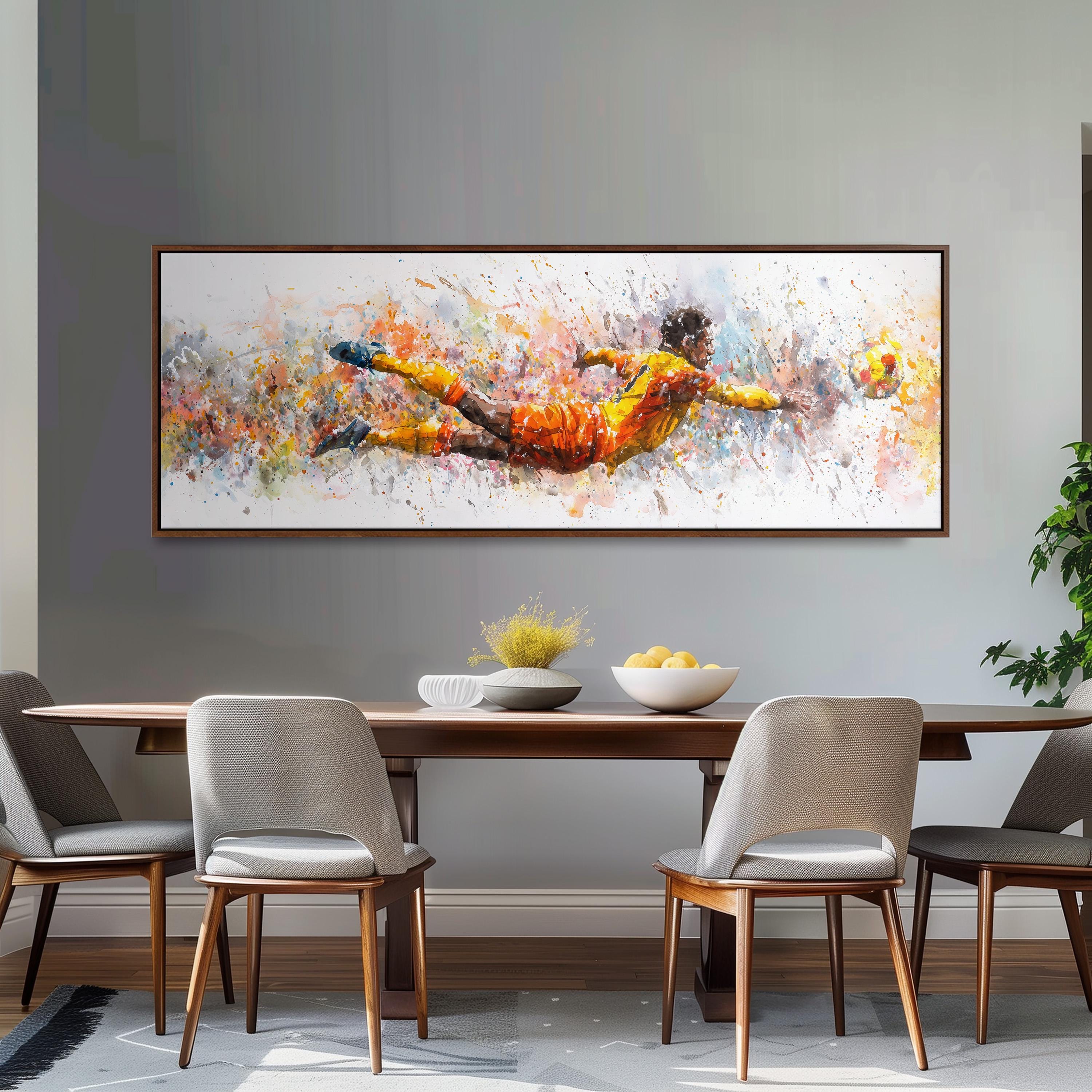 a large, colorful painting of a soccer player diving to catch a ball, hanging on a wall above a wooden dining table with four chairs.