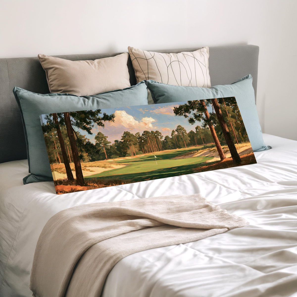 Golf fairway lined with tall pines wide panoramic canvas print laid on a bed to show its size