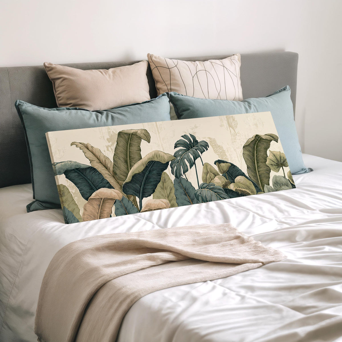 Vintage tropical leaves wide panoramic canvas print laid on a bed to show its size