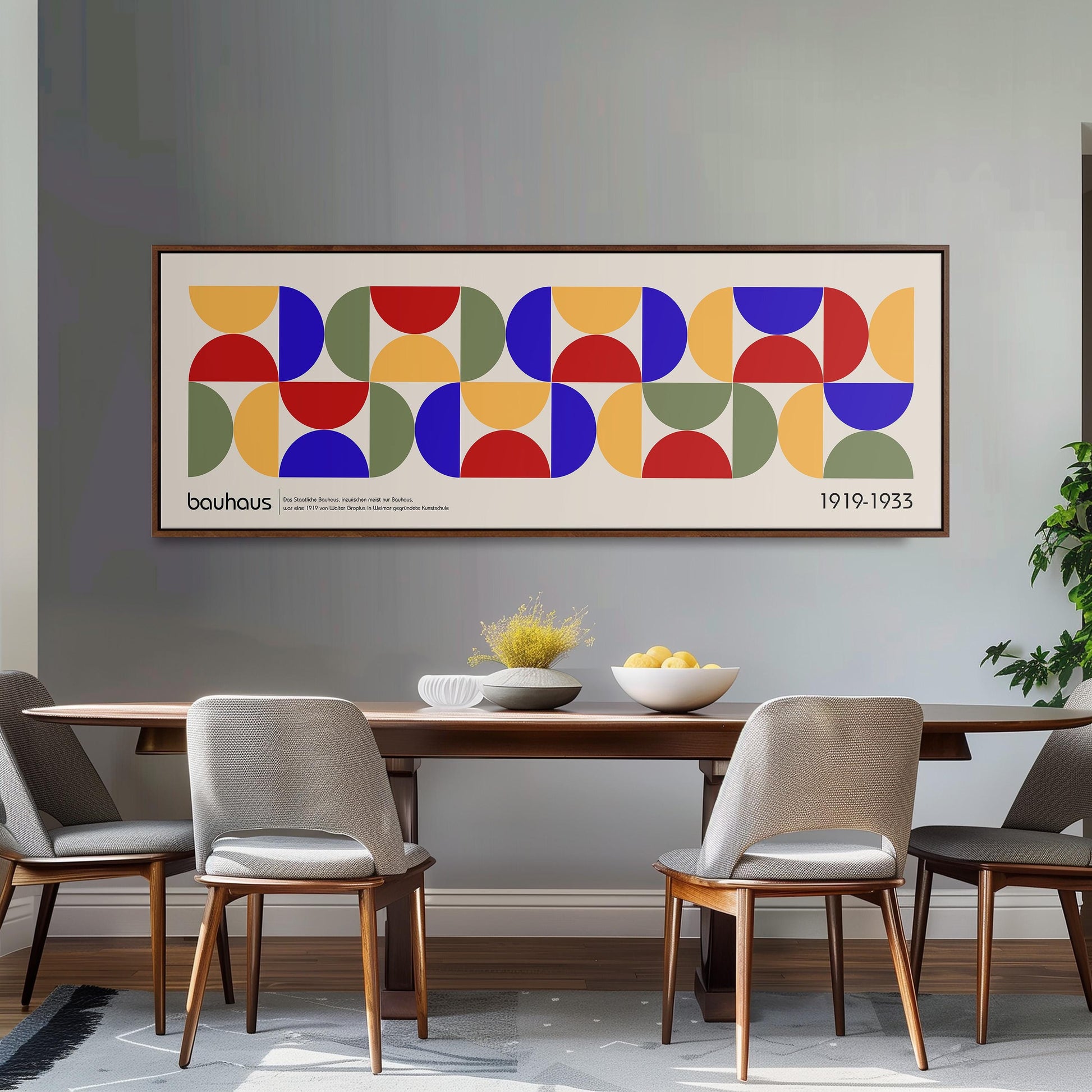 a dining room with a large abstract painting hanging on the wall above a wooden table with four chairs. The painting consists of a series of colorful geometric shapes, creating a vibrant and modern design.
