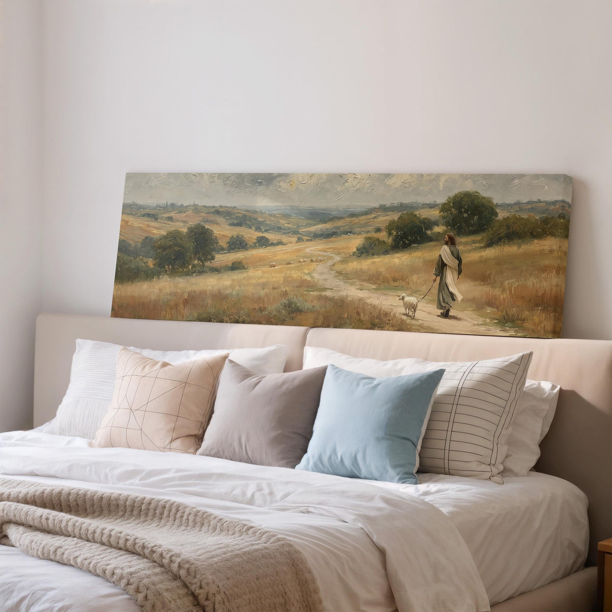 Jesus walking with a sheep on a golden hillside wide panoramic canvas print above a bed in a bedroom