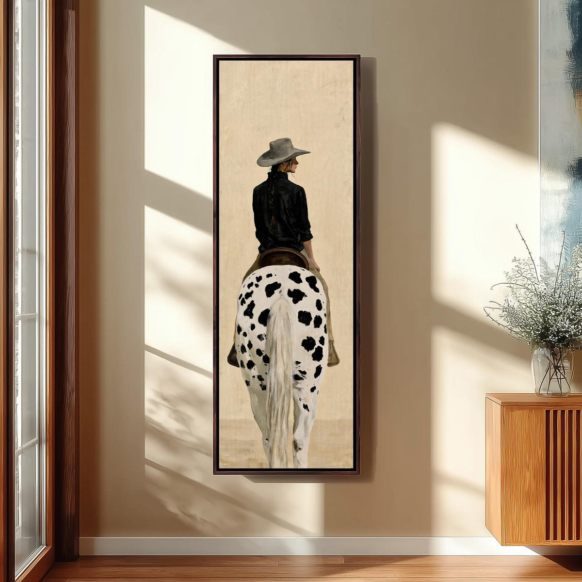 Cowgirl with a long braid on a spotted horse tall skinny canvas print in a sunlit living space