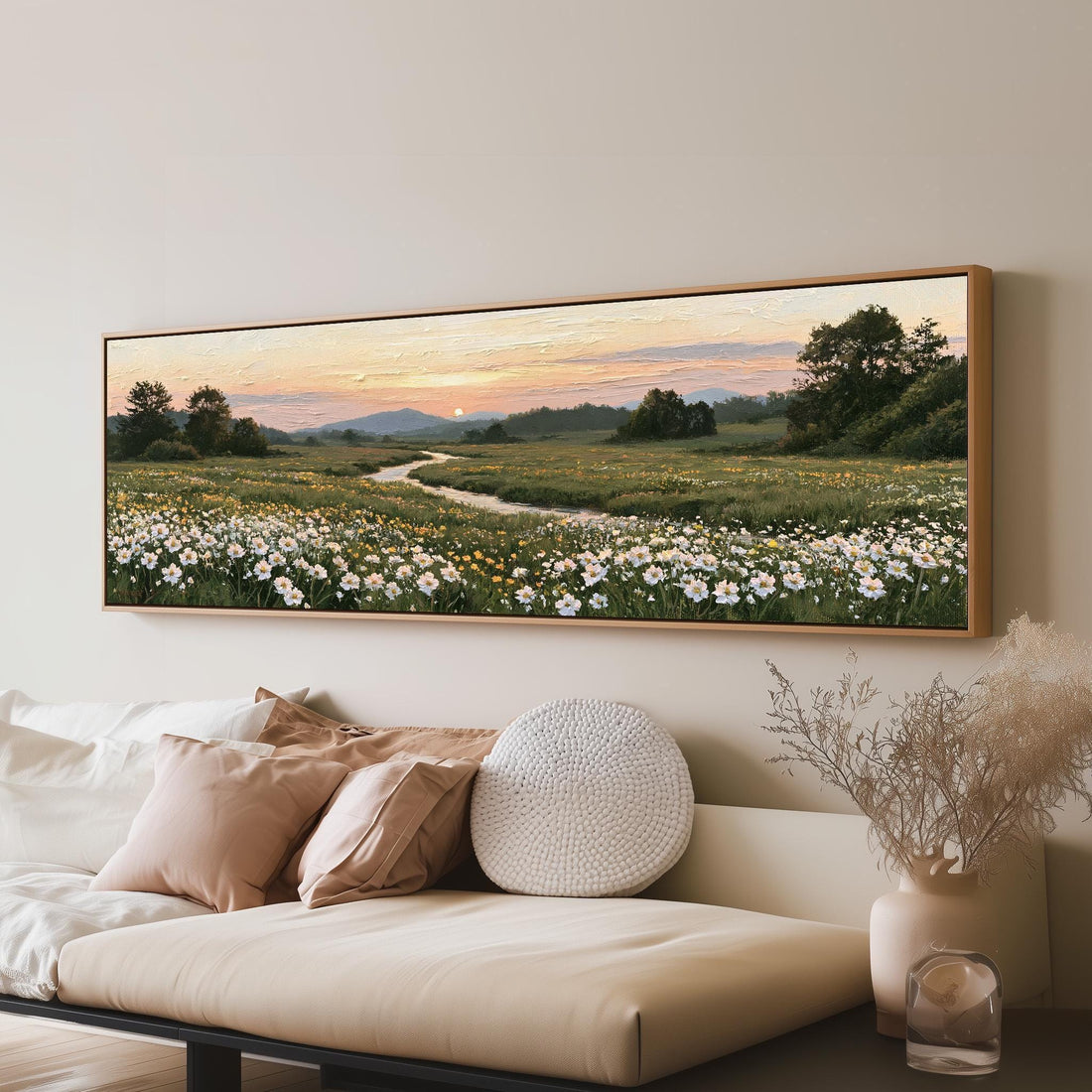 Daisy meadow with a winding stream at sunset long horizontal canvas print above a sofa in a living room