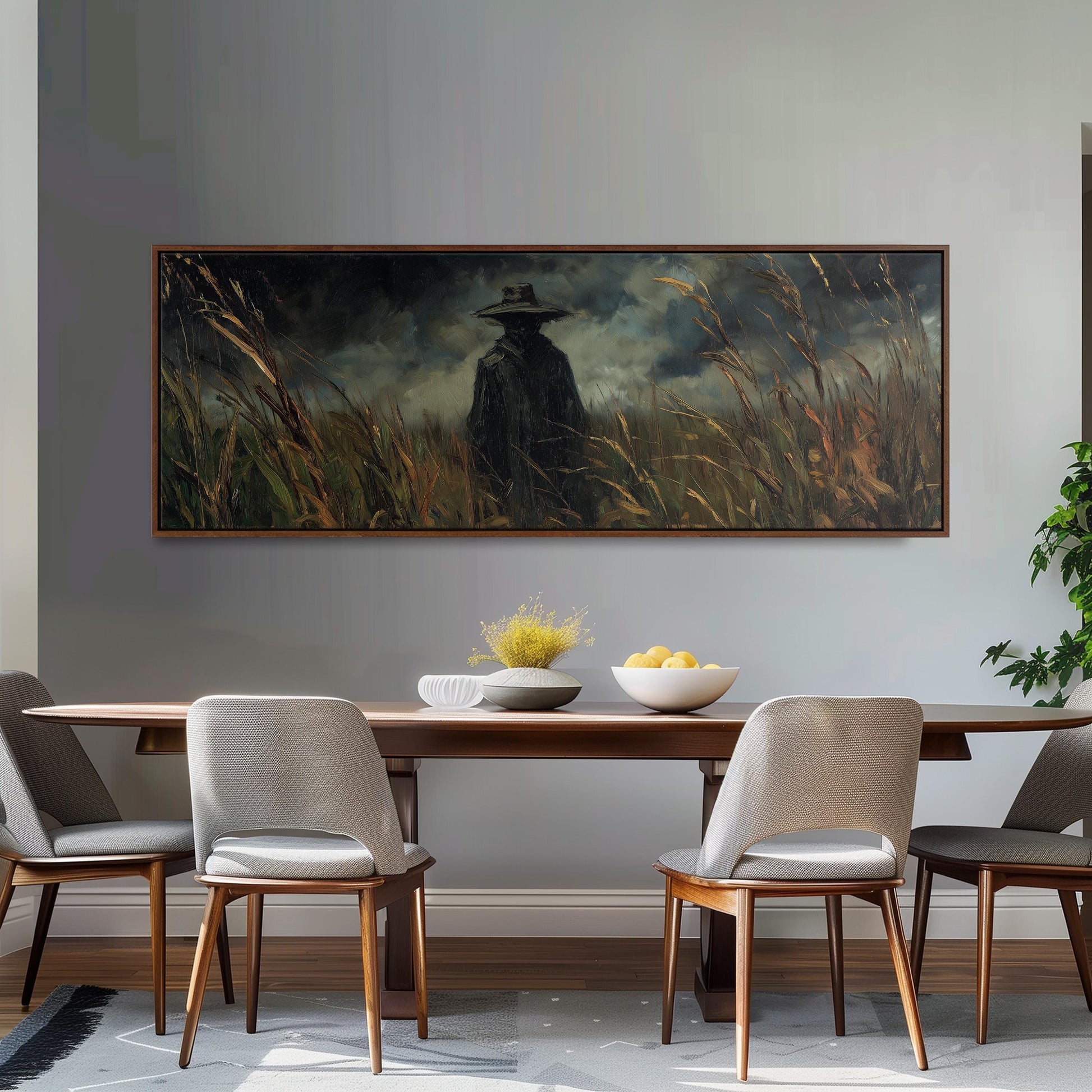 a dining room with a large painting of a person in a hat and coat standing in a field of tall grass, which is hanging on the wall above a wooden dining table with four chairs.