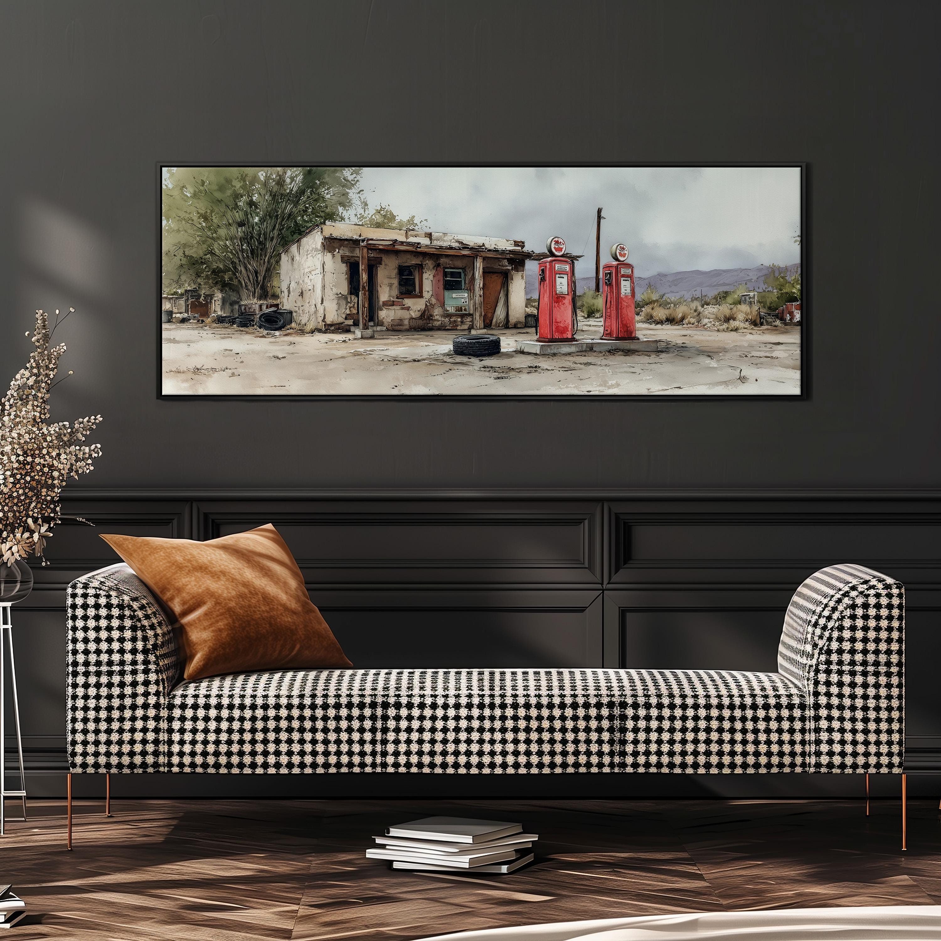 a checkered sofa with a brown throw pillow, positioned in front of a large framed painting depicting a dilapidated building with two red gas pumps.