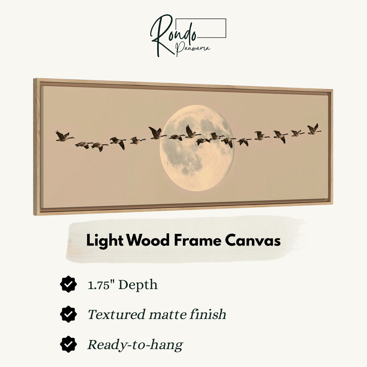 Geese flying across a pale moon on sand canvas print in a light wood floating frame