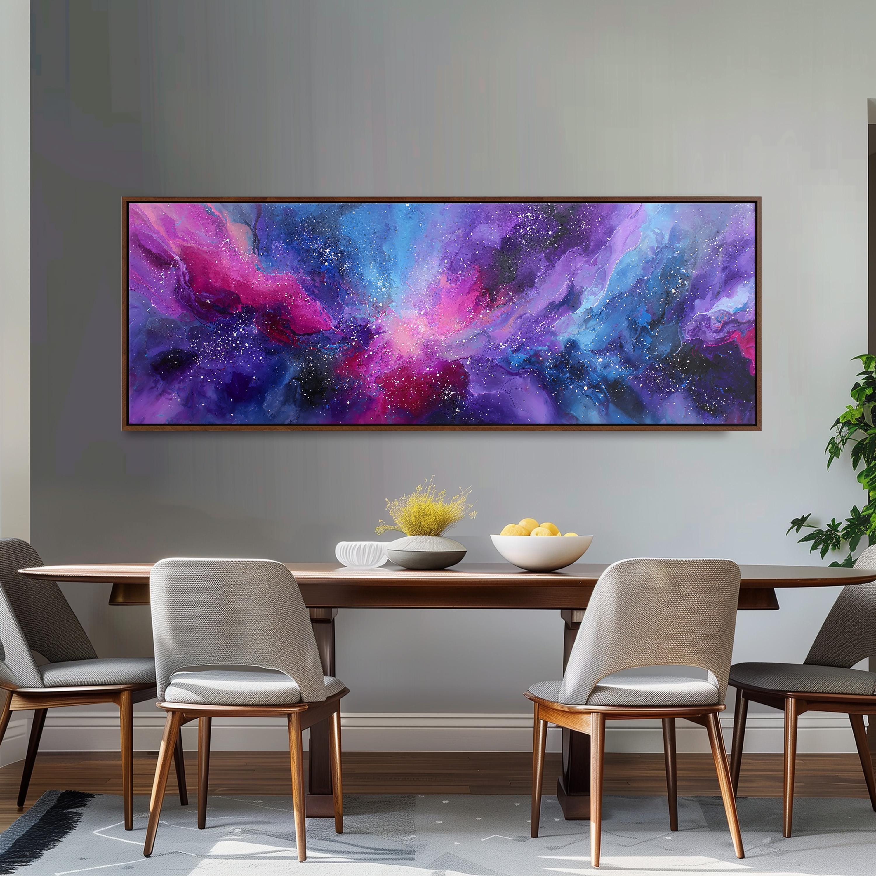 a dining room with a large, colorful abstract painting hanging on the wall above a wooden dining table. The table is set with a bowl of fruit and a vase of flowers, creating a cozy and inviting atmosphere.
