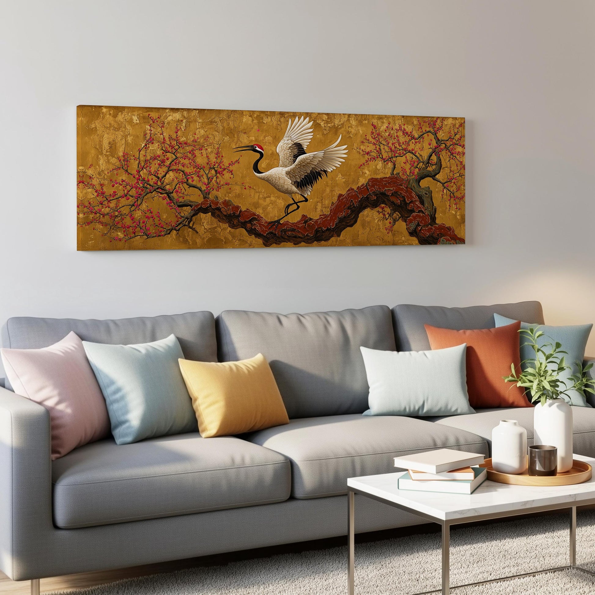 a large, colorful painting of a crane in flight above a gray couch in a living room setting.