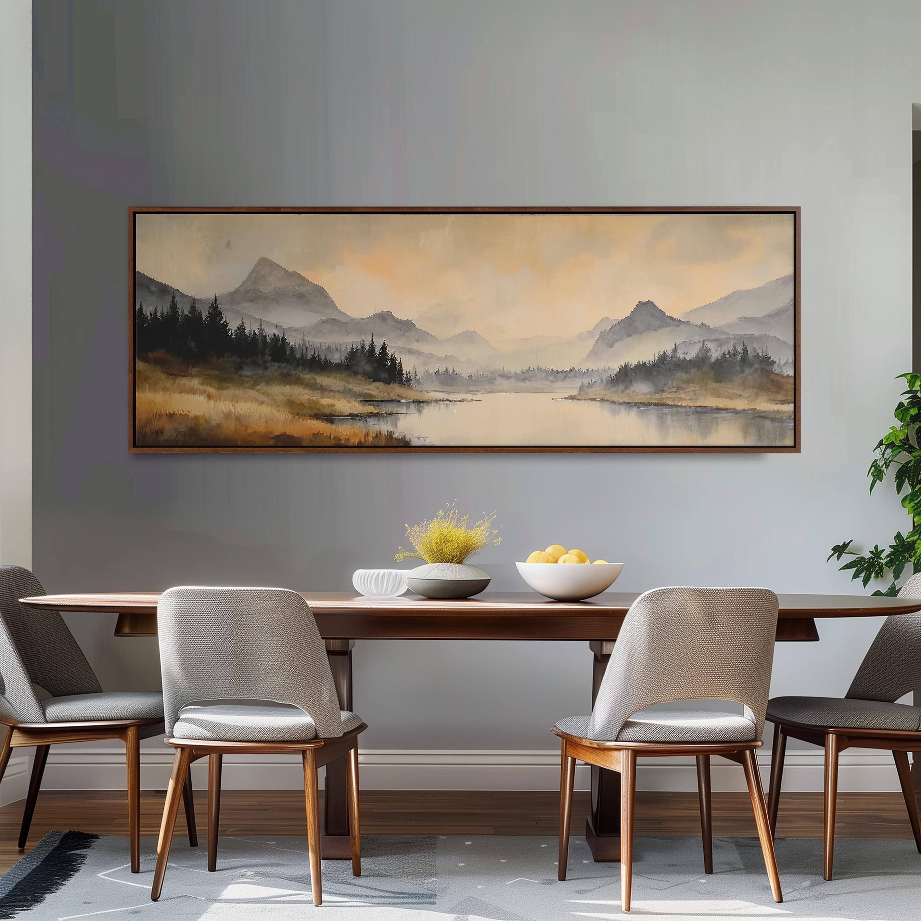 a dining room with a large painting of a mountain landscape hanging on the wall above a wooden dining table with four chairs. The painting depicts a serene mountain scene with a lake and trees in the background.