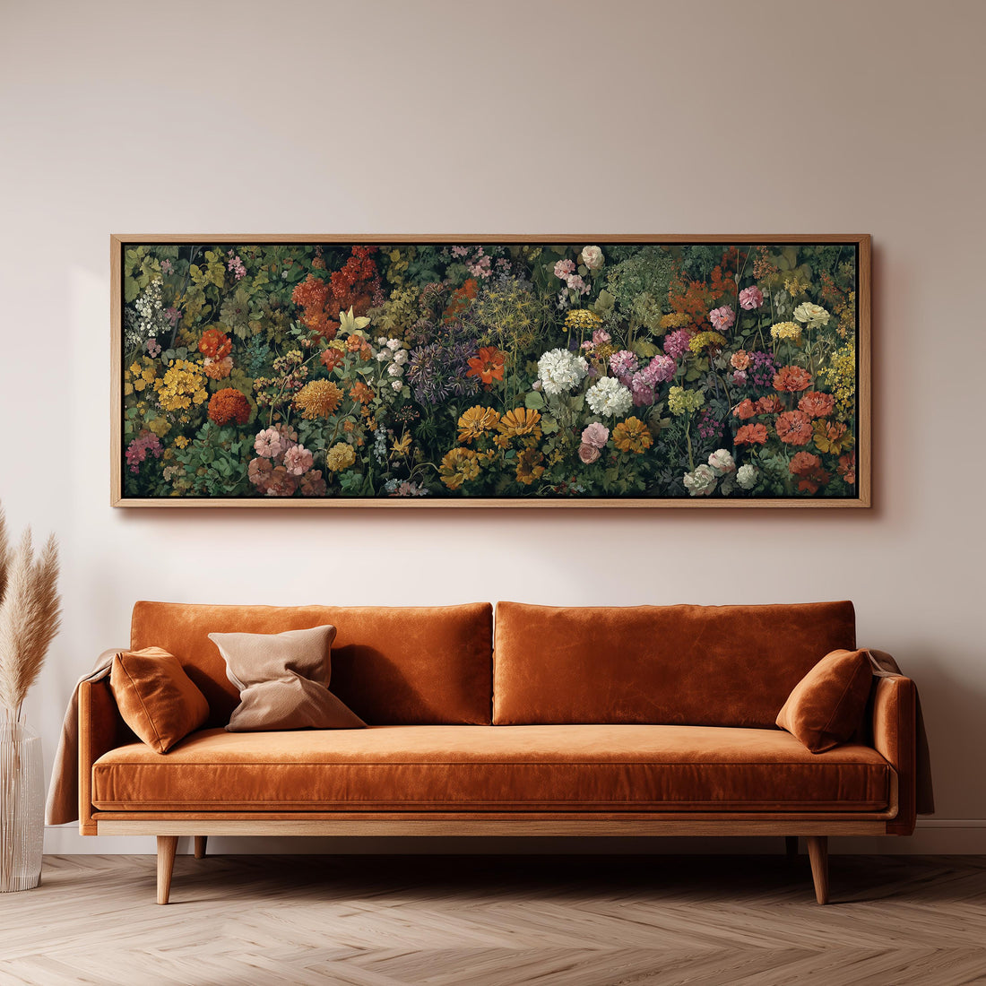 a wooden cabinet with a vase of greenery, a coffee cup, and a stack of books on top. Above the cabinet, there is a large painting depicting a vibrant floral scene.