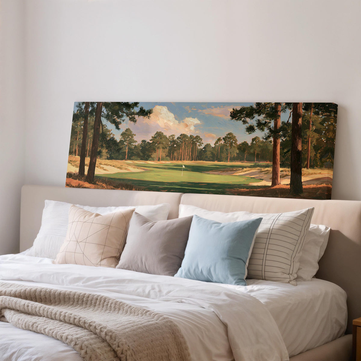 Golf fairway lined with tall pines wide panoramic canvas print above a bed in a bedroom