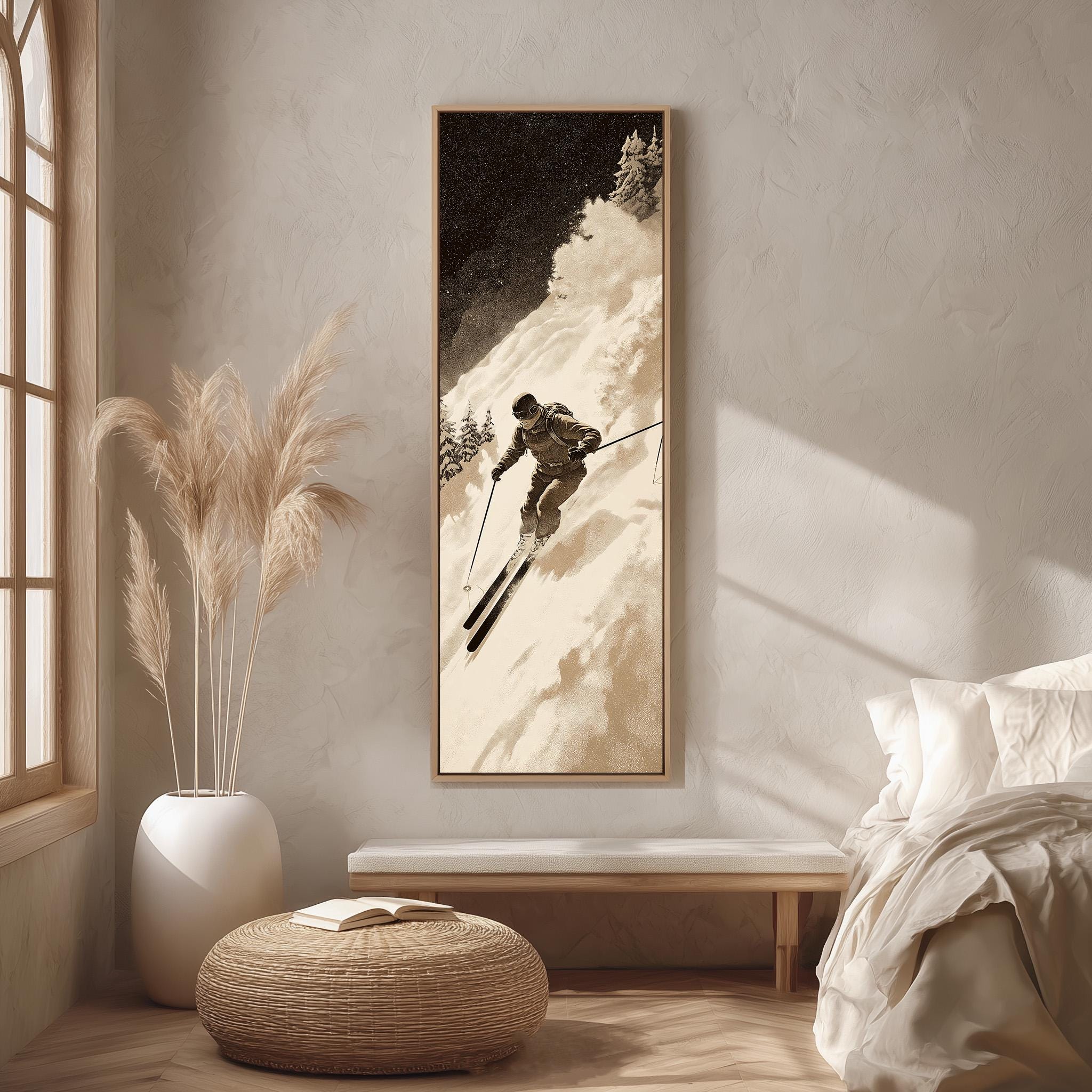 a cozy bedroom scene with a large framed picture of a skier on the wall, a white bed with a white pillow, a white ottoman, and a potted plant.