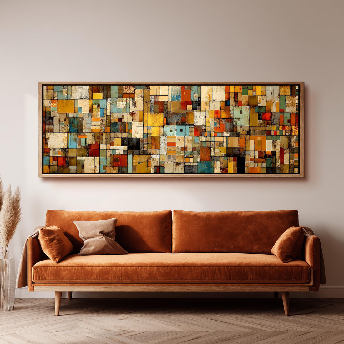 a large, colorful abstract painting hanging on a wall above a brown sofa with two pillows.