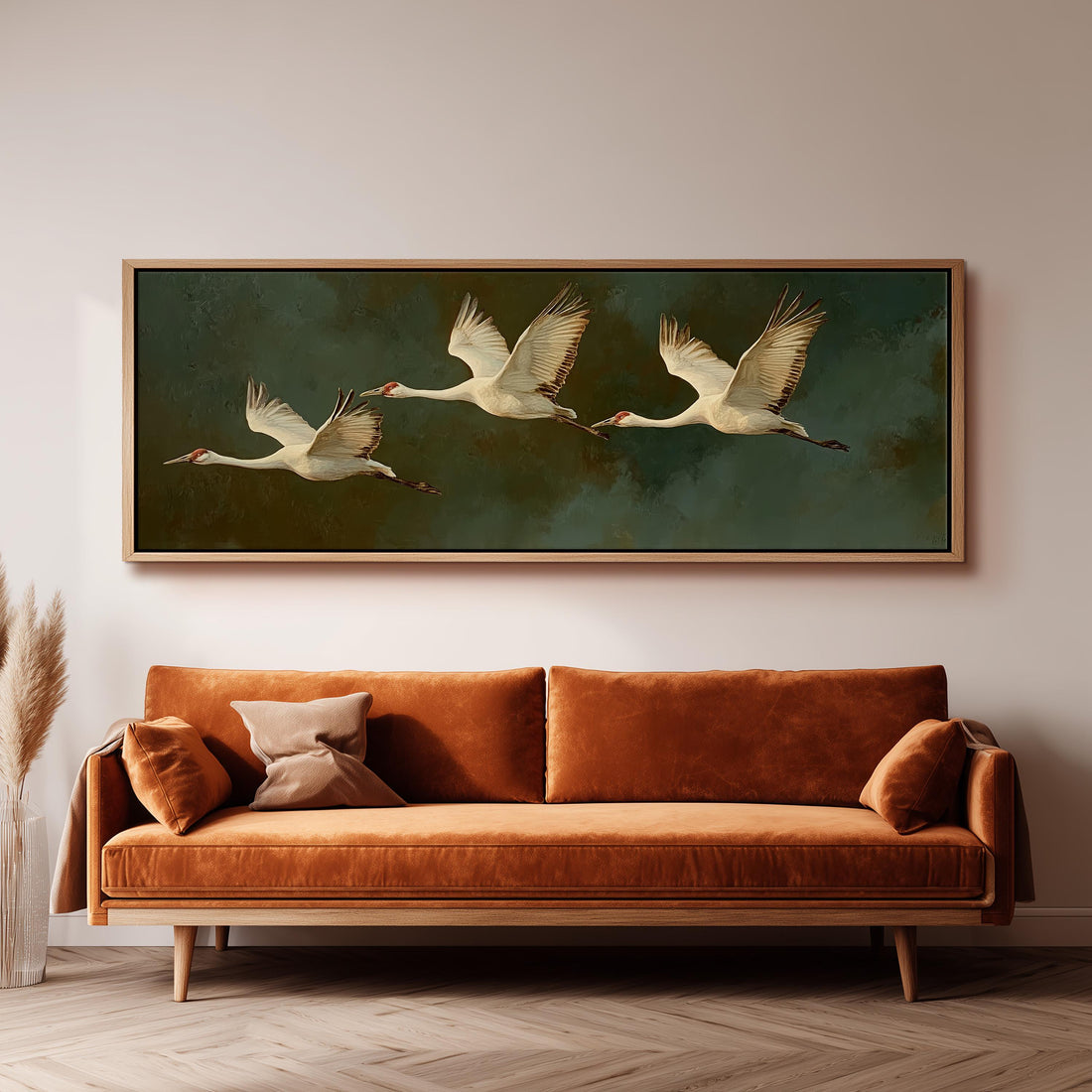 a dining room with a large painting of three white birds in flight above a wooden table. The table is set with a bowl of fruit and a vase of flowers, creating a cozy and inviting atmosphere.
