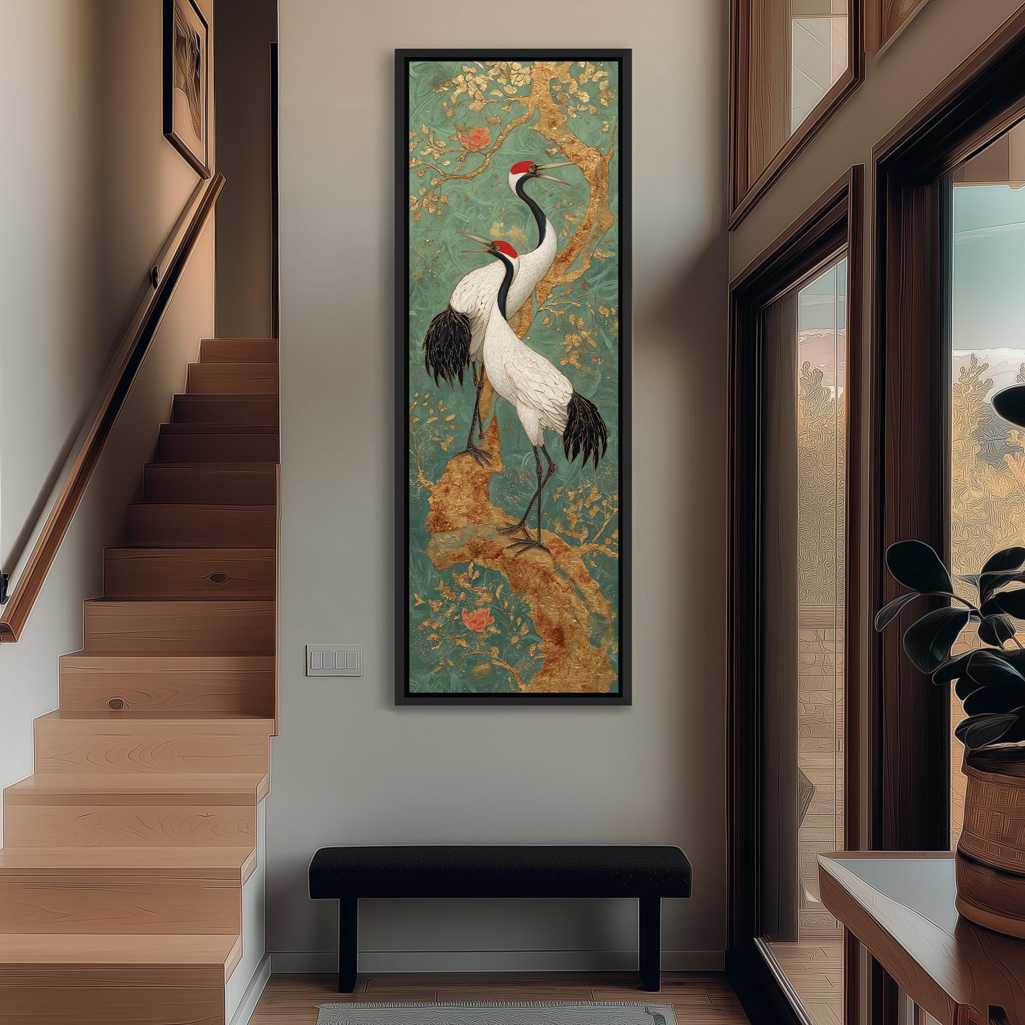 a large painting of two white birds with black and red accents, standing on a branch with a green and gold background, hanging on a wall in a hallway.