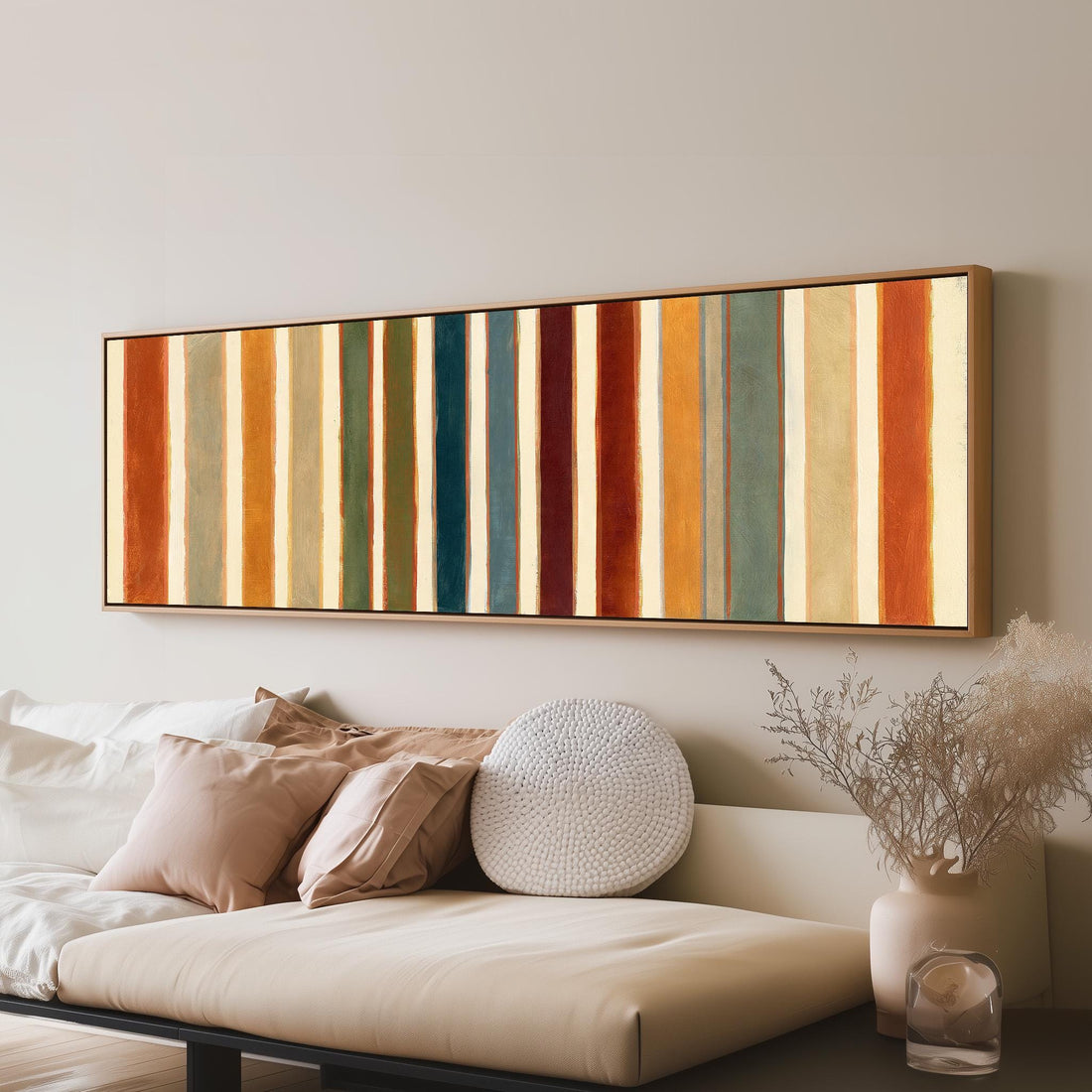 Rust, sage, maroon and teal stripes long horizontal canvas print above a sofa in a living room