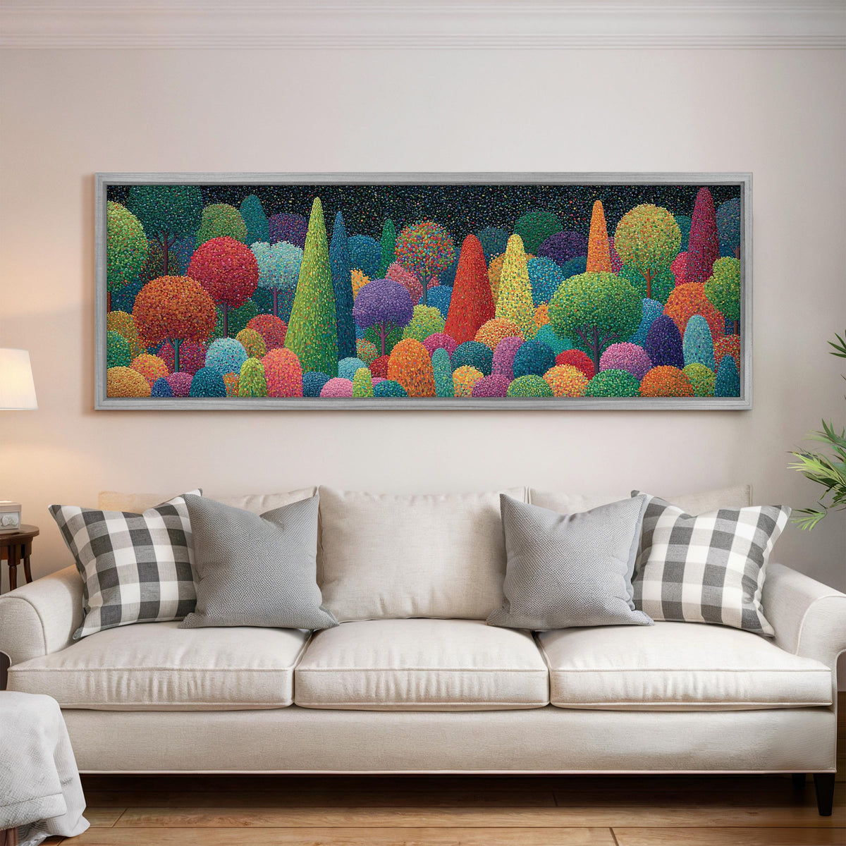 Whimsical rainbow pointillist forest panoramic canvas print above a white sofa in a bright living room