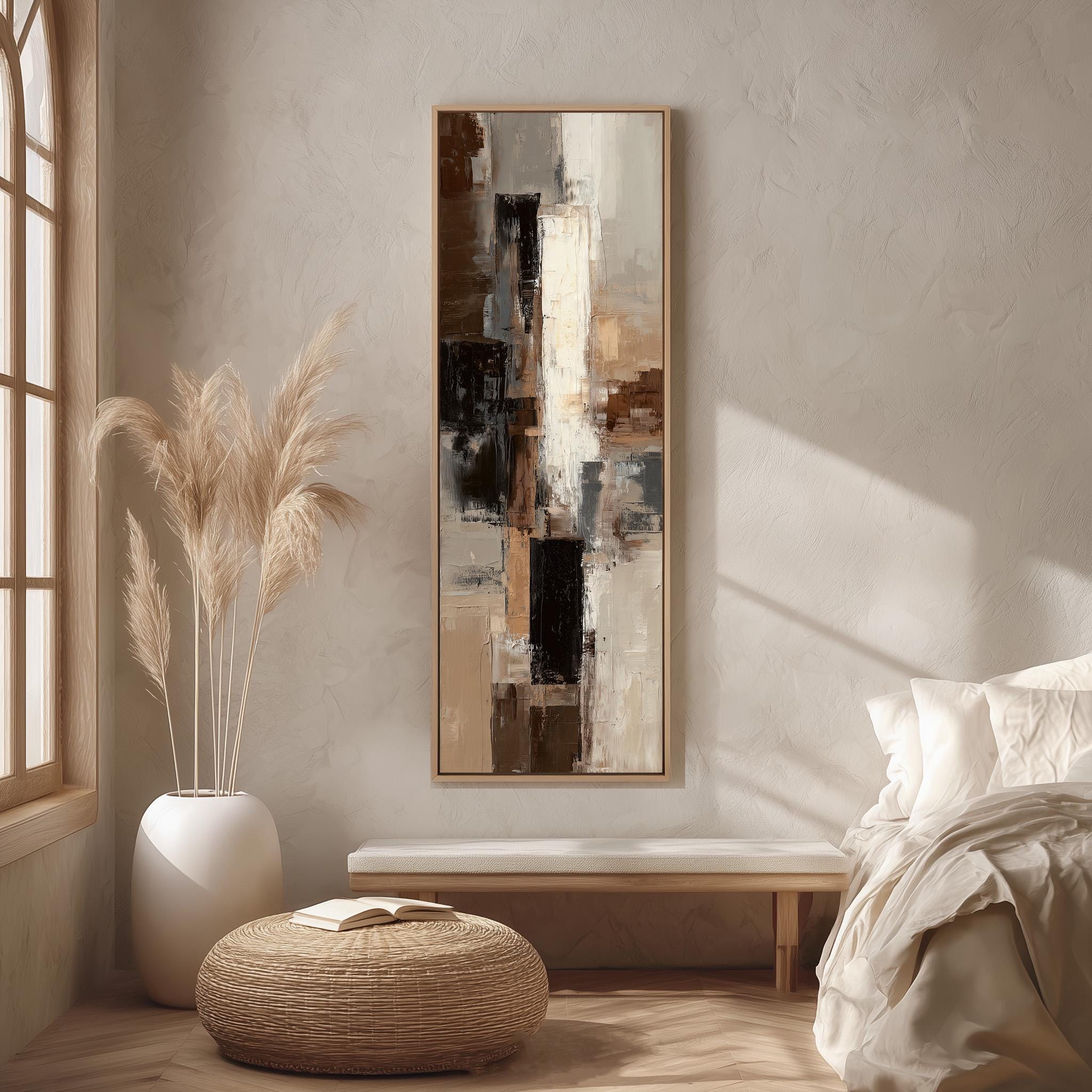 a serene and modern bedroom with a large abstract painting hanging on the wall, a white bed with a white pillow, a white wicker ottoman, and a large window with white curtains.