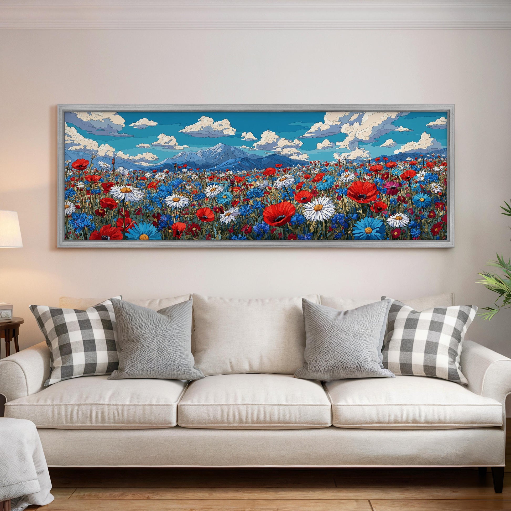 a large, colorful painting of a flower field hanging on a wall above a white couch with gray and white pillows.