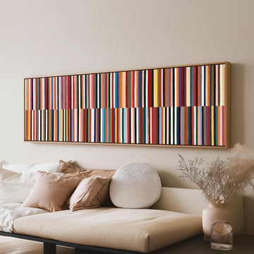 Two bands of colorful stripes long horizontal canvas print above a sofa in a living room